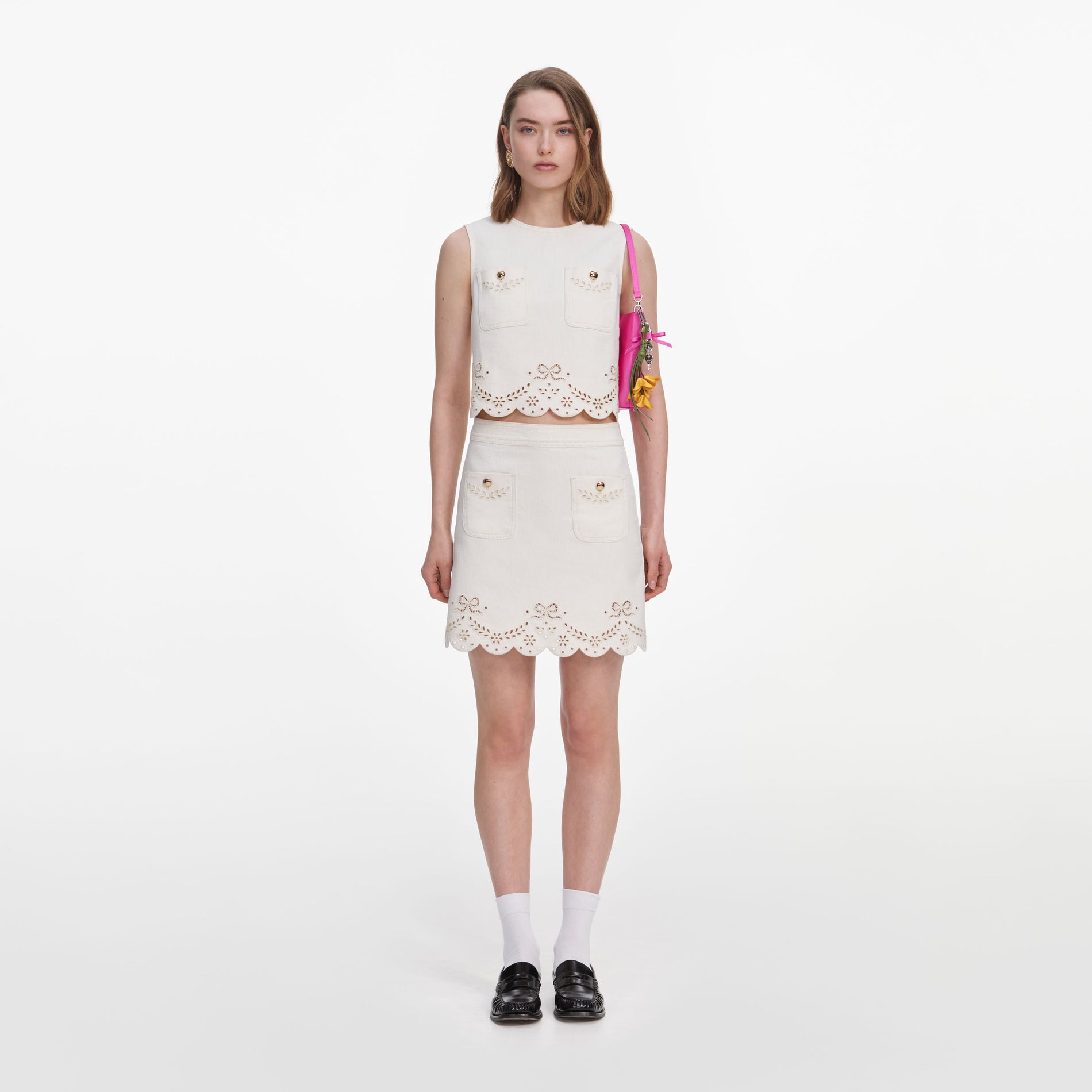 Front view of a woman wearing the Cream Broderie Denim Mini Skirt