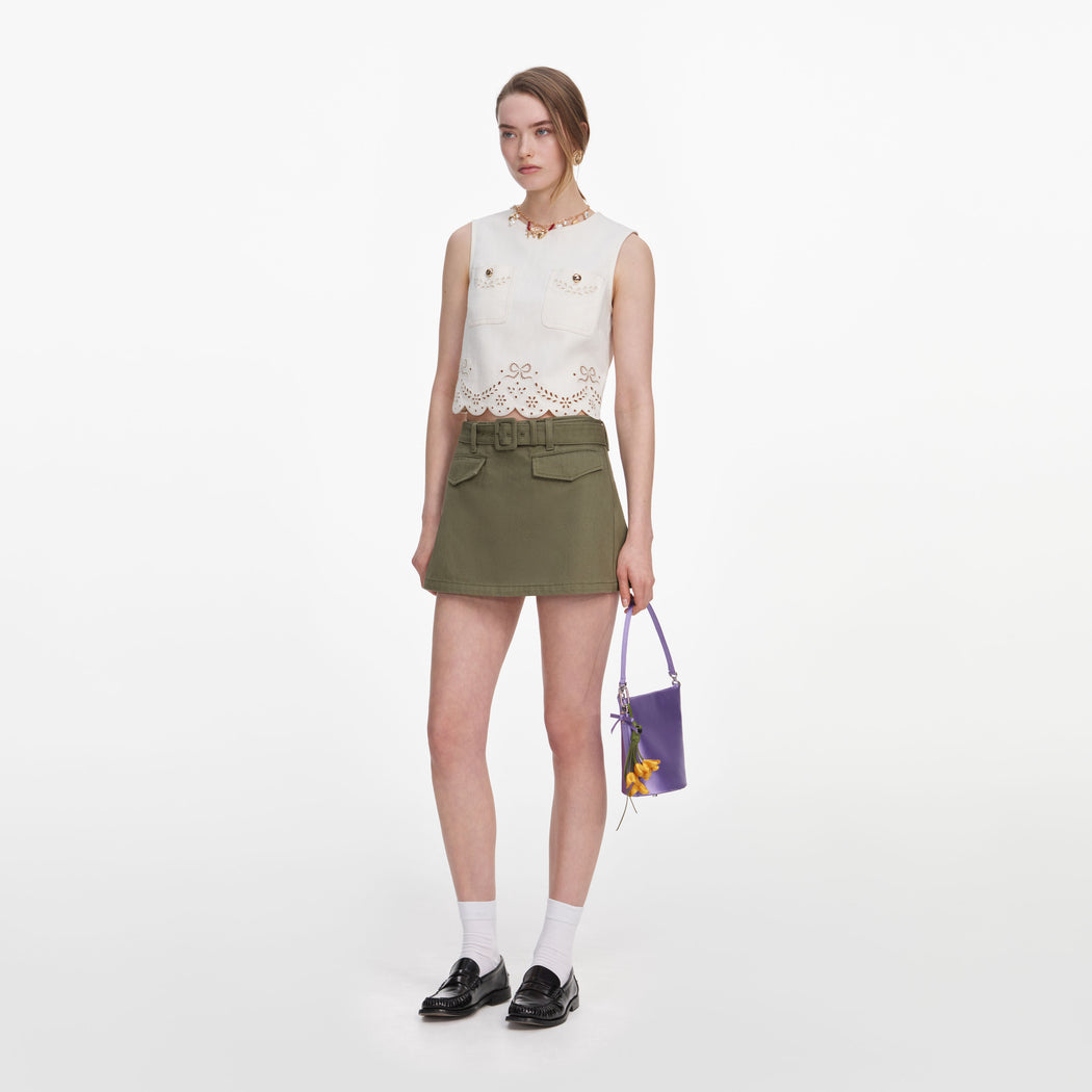 Side view of a woman wearing the Cream Broderie Denim Top