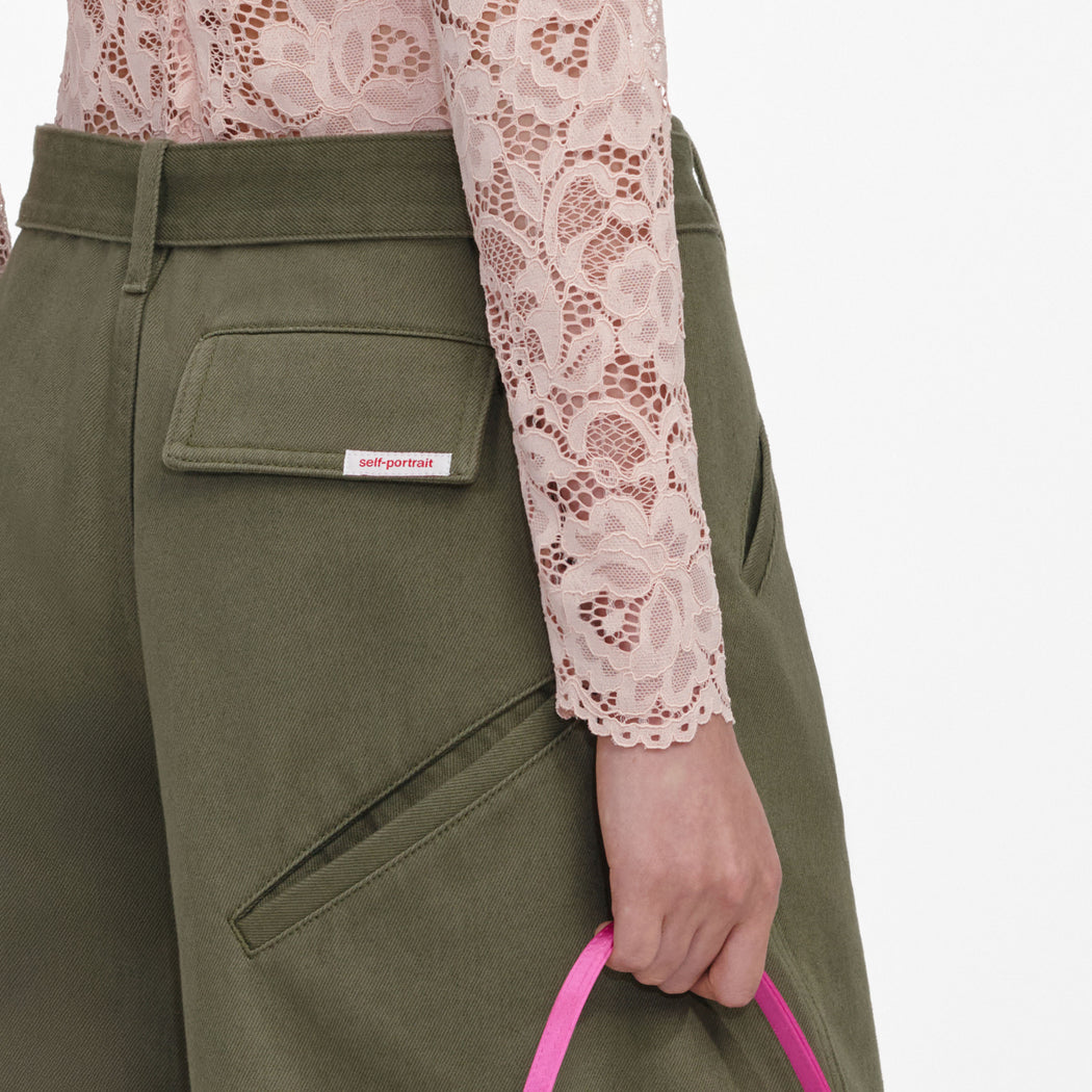 A close up of a woman wearing the Khaki Cargo Jeans