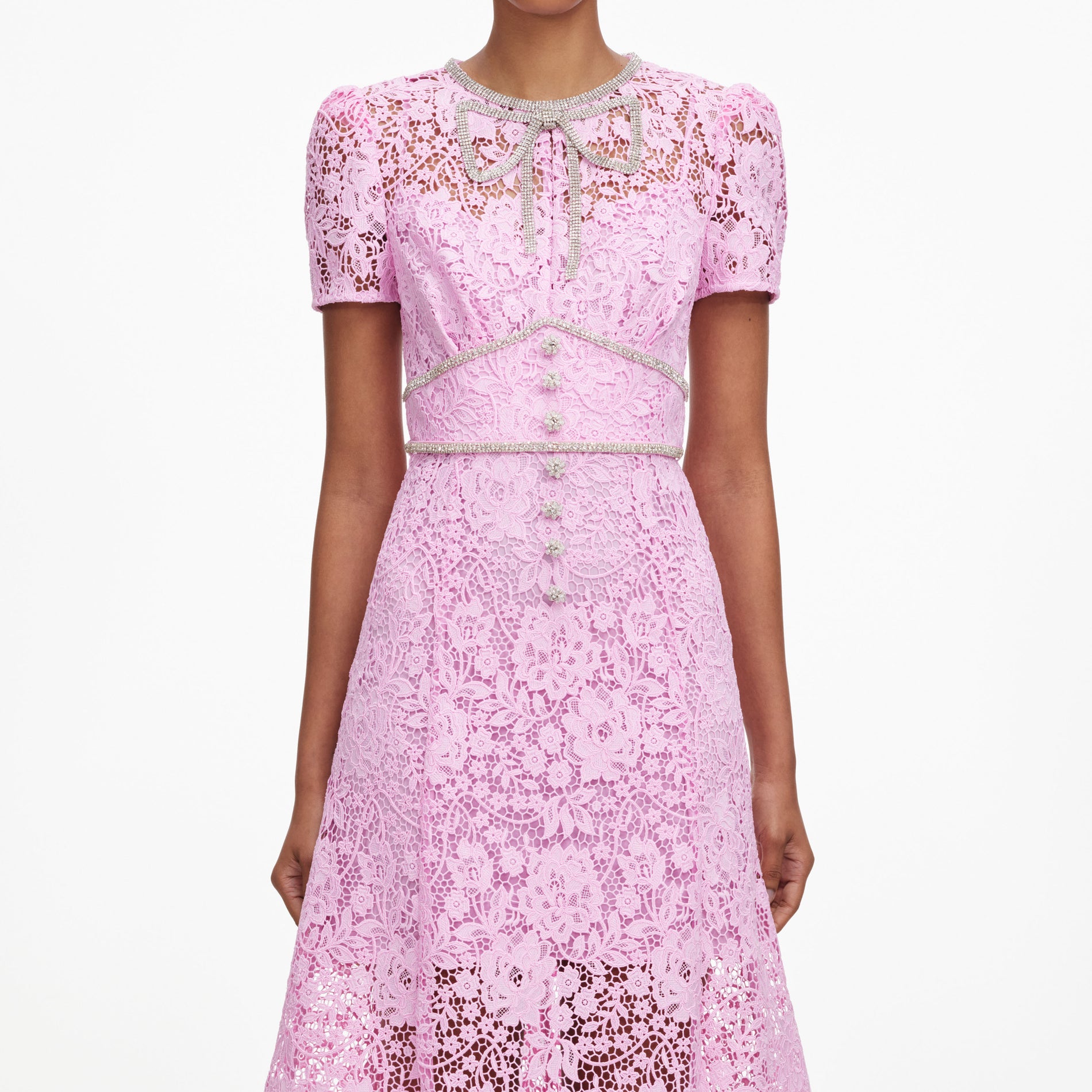 A close up of a woman wearing the Pink Cord Lace Midi Dress