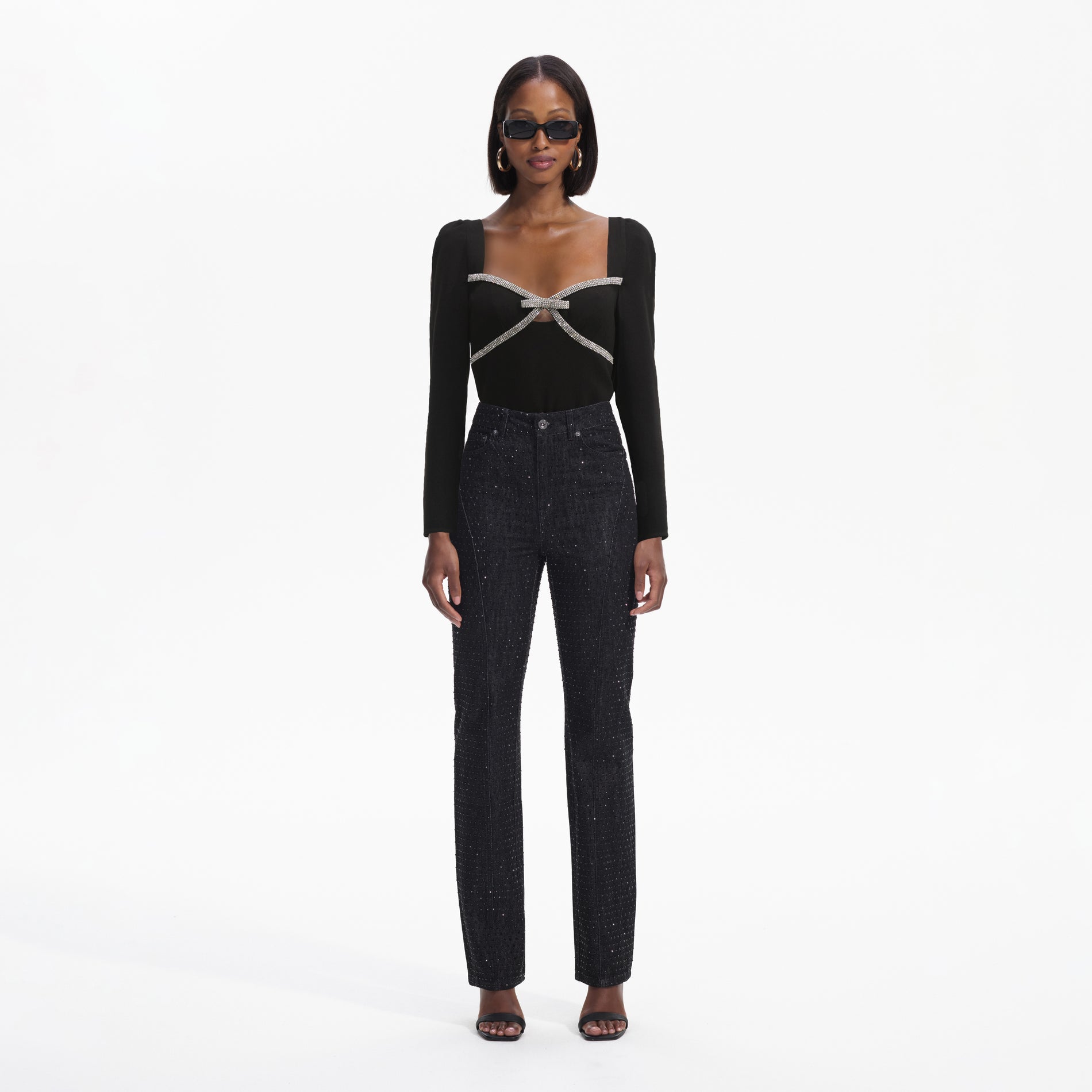 Front view of a woman wearing the Black Diamante Bow Top