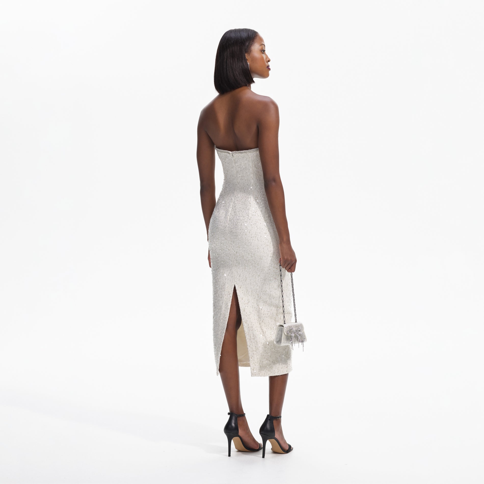 Back view of a woman wearing the Cream Sequin Boucle Strapless Midi Dress
