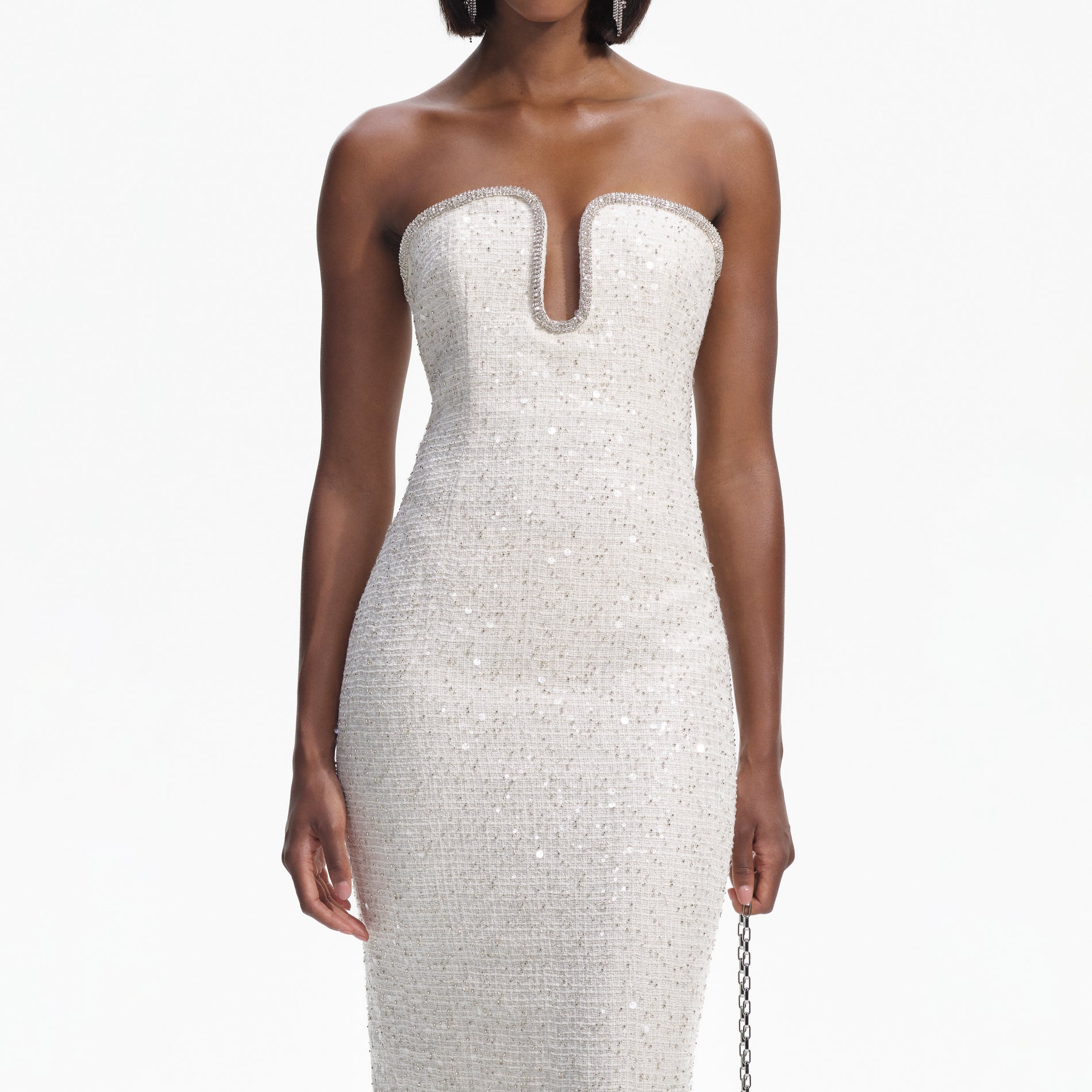 A close up of a woman wearing the Cream Sequin Boucle Strapless Midi Dress