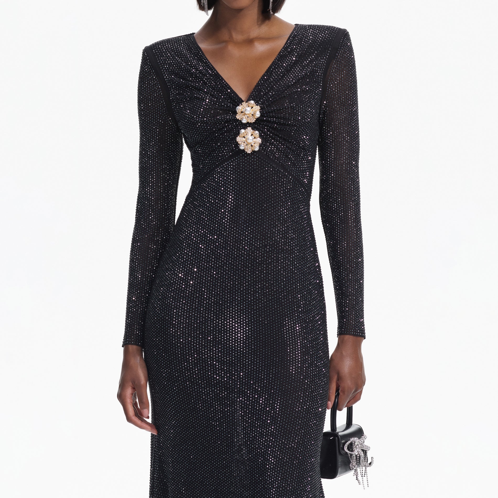 A close up of a woman wearing the Black Rhinestone Mesh V-Neck Midi Dress