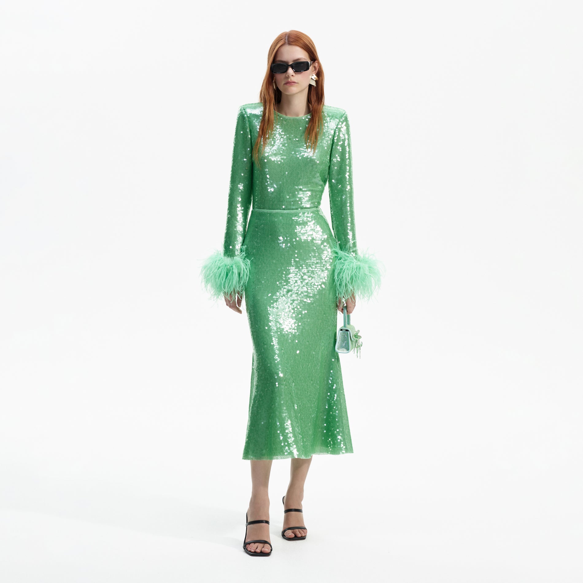 Front view of a woman wearing the Mint Sequin Midi Skirt