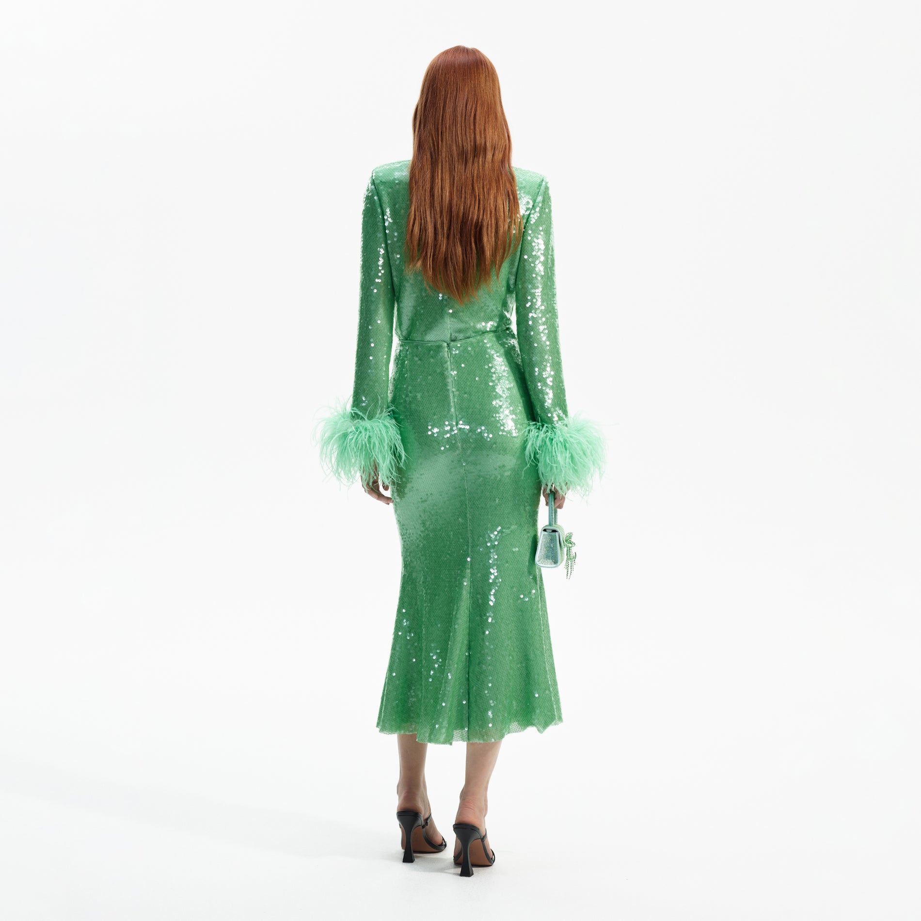 Back view of a woman wearing the Mint Sequin Midi Skirt