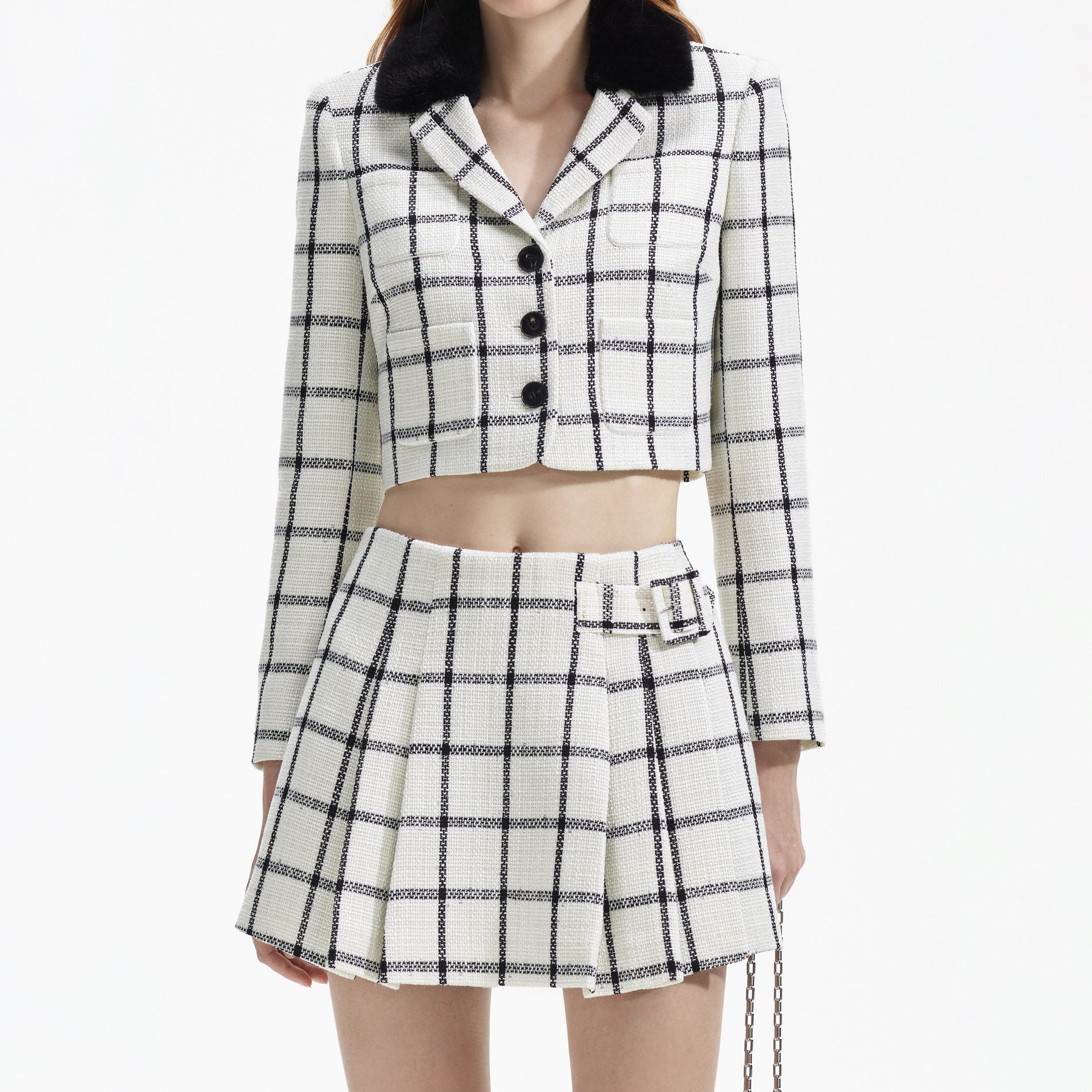 A close up of a woman wearing the Cream Check Skort