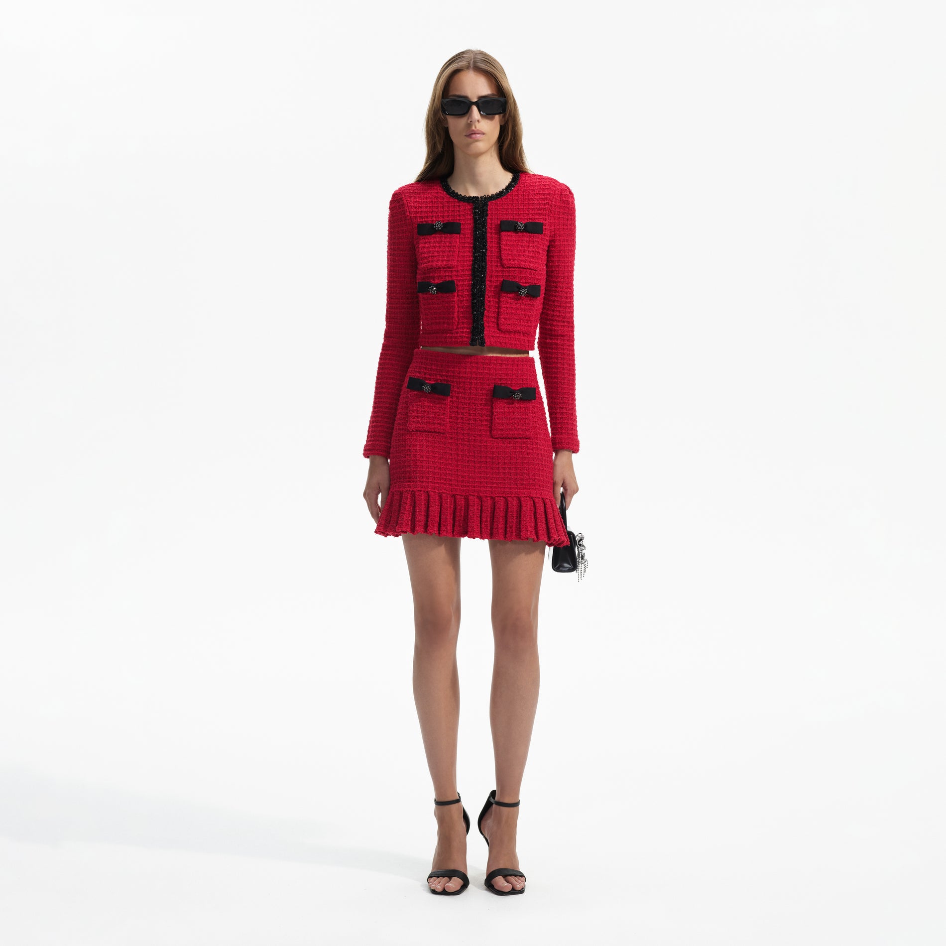Front view of a woman wearing the Red Knit Cardigan