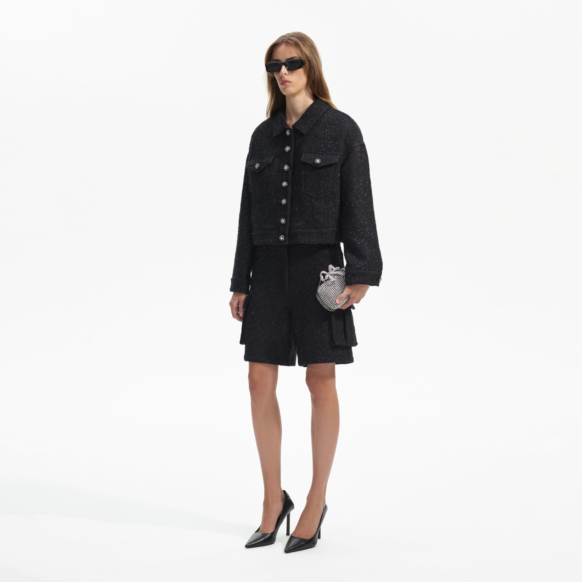 Side view of a woman wearing the Black Boucle Oversized Jacket
