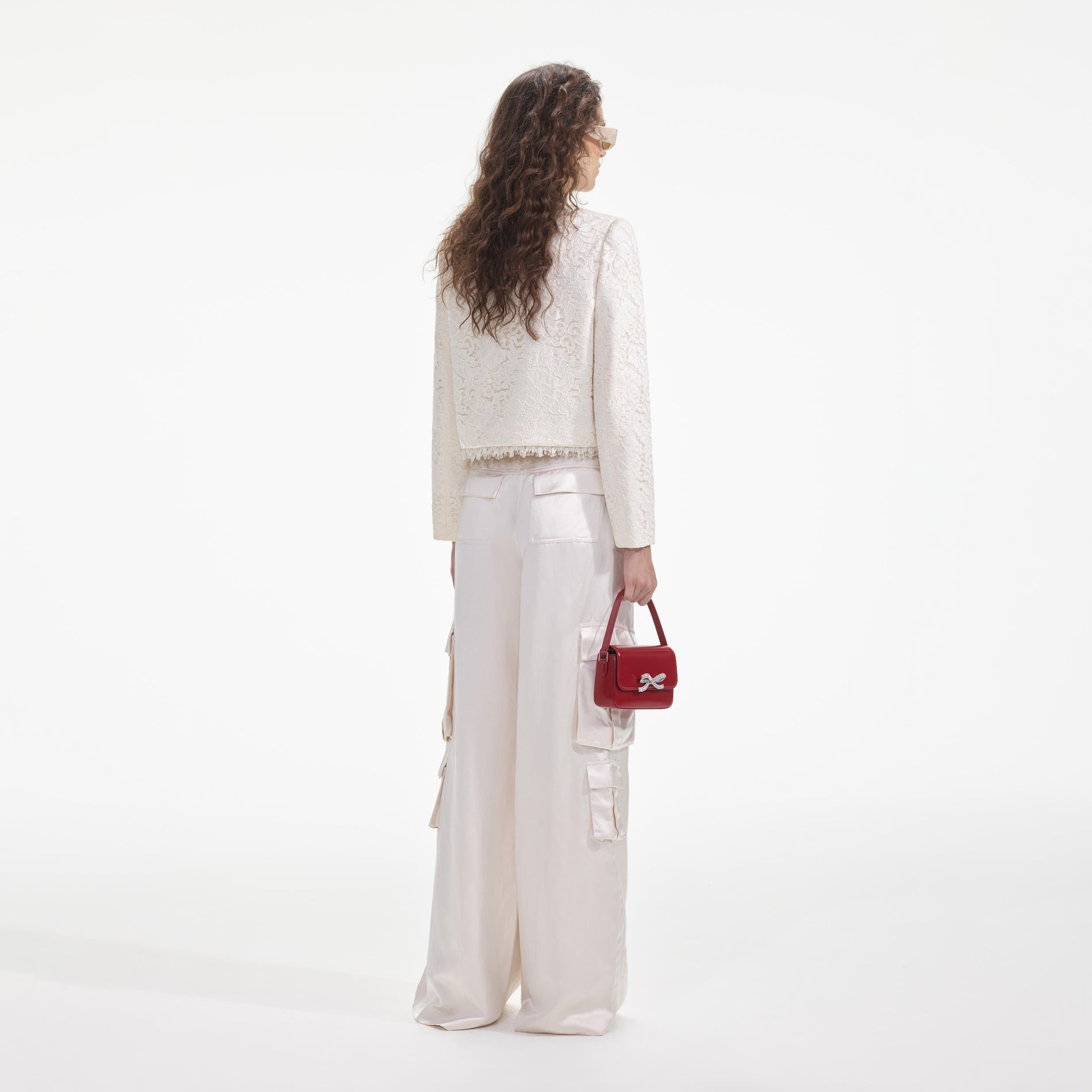 Back view of a woman wearing the Cream Cord Lace Jacket