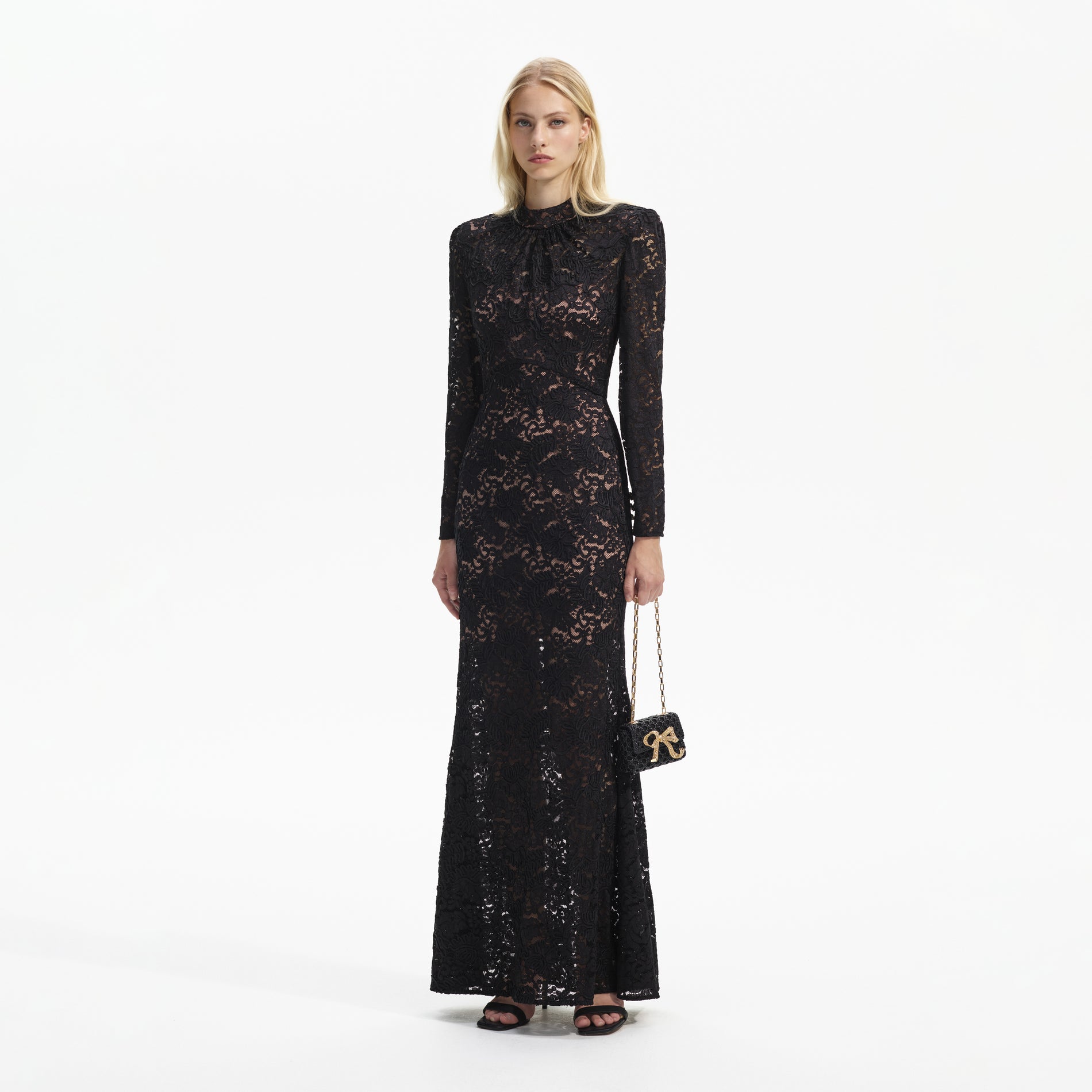 Side view of a woman wearing the Black Cord Lace Maxi Dress