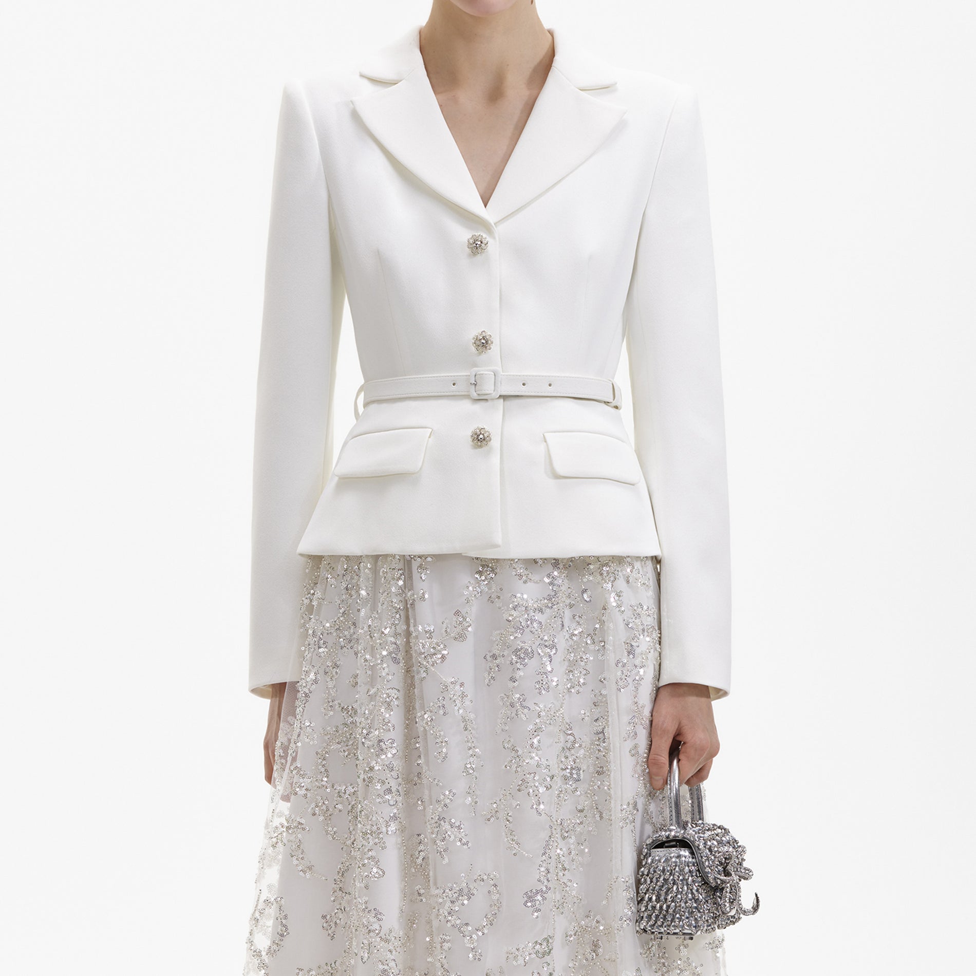 A close up of a woman wearing the White Crepe Embellished Midi Dress