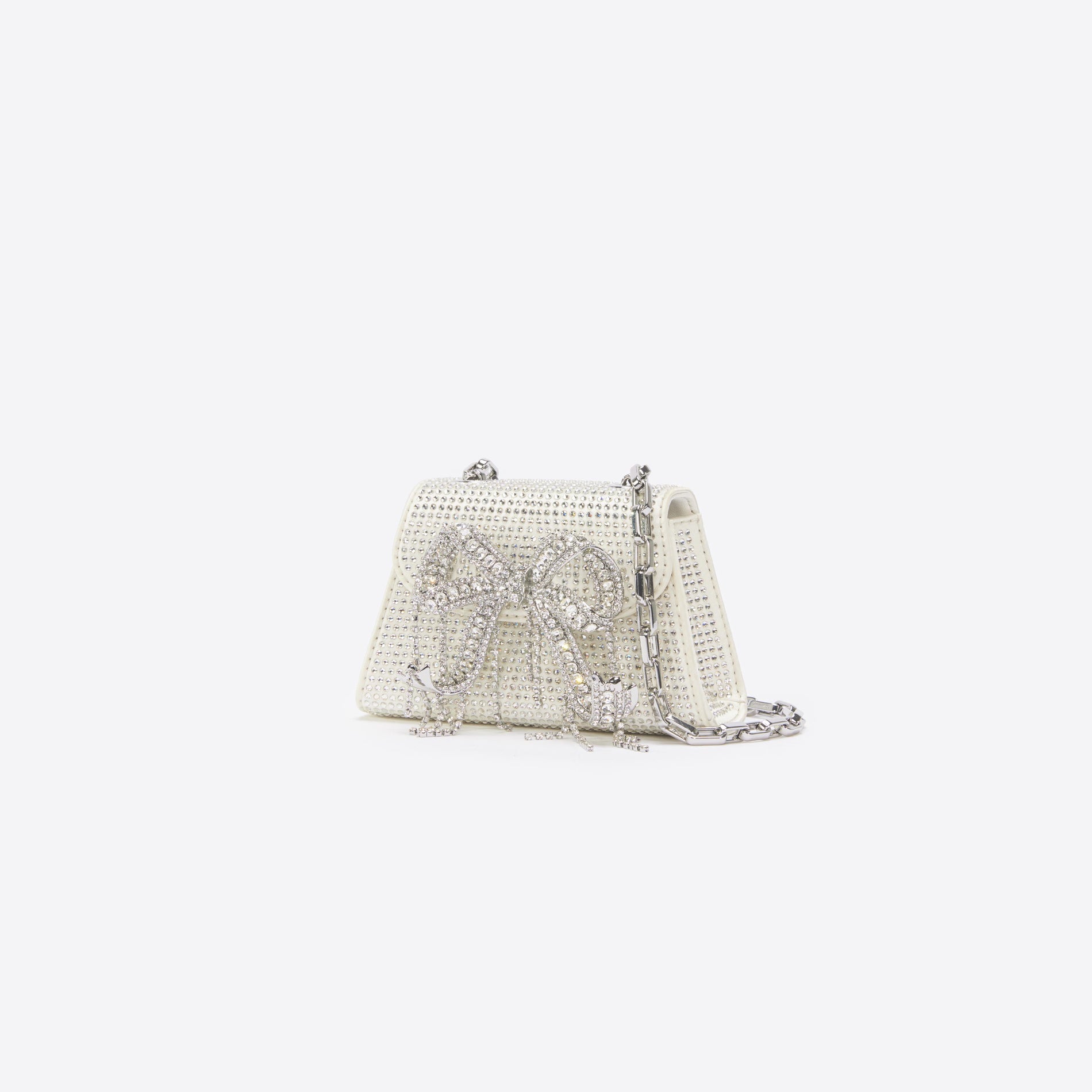 Side view of a woman wearing the Cream Rhinestone Micro Bow Bag