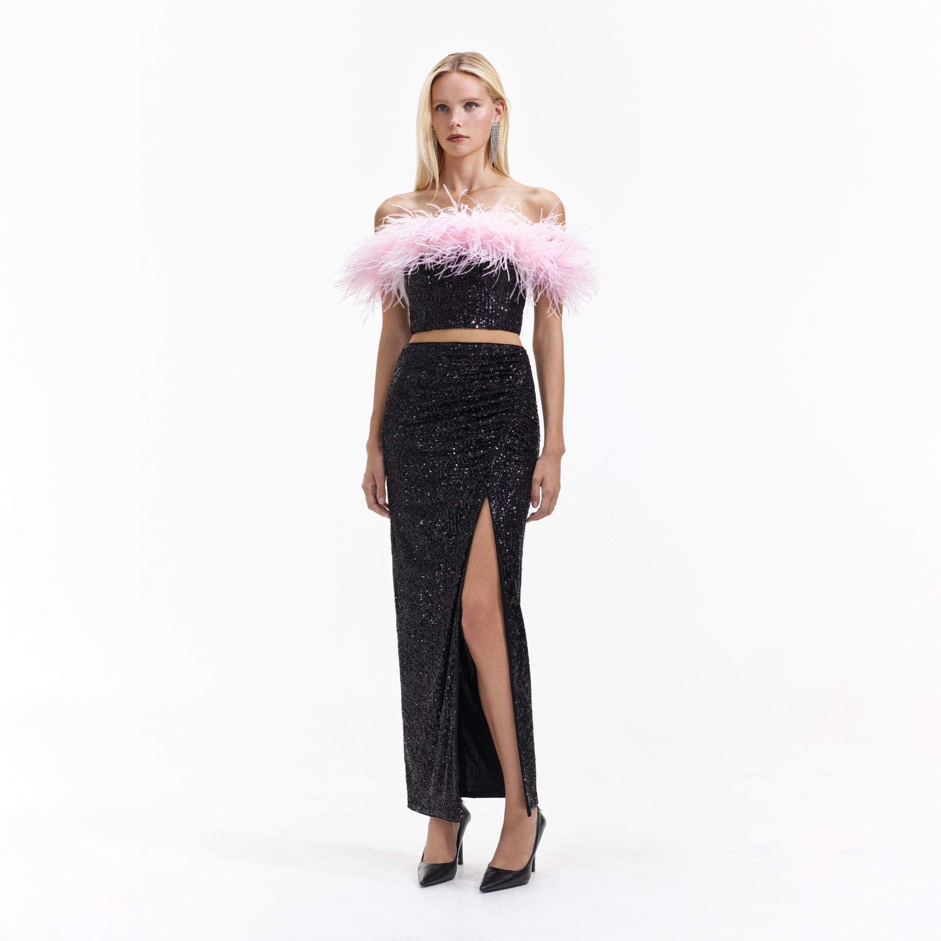 Side view of a woman wearing the Black Sequin Maxi Skirt
