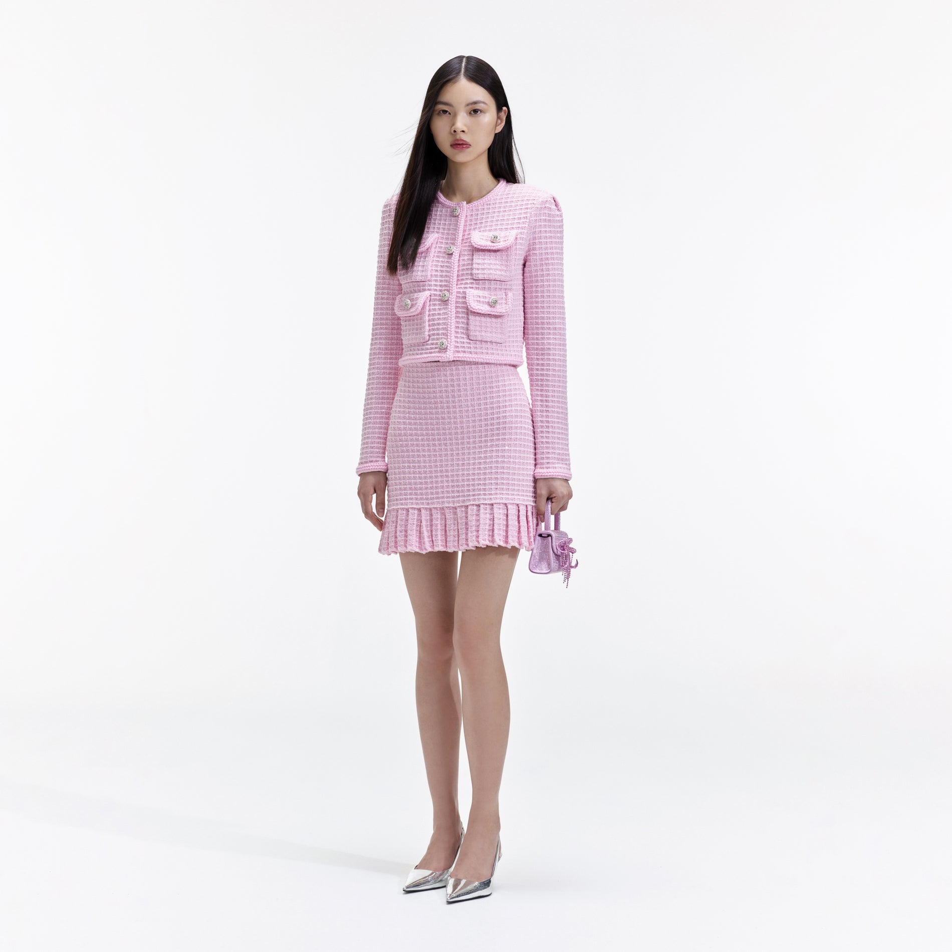 Side view of a woman wearing the Pink Sequin Textured Knit Skirt