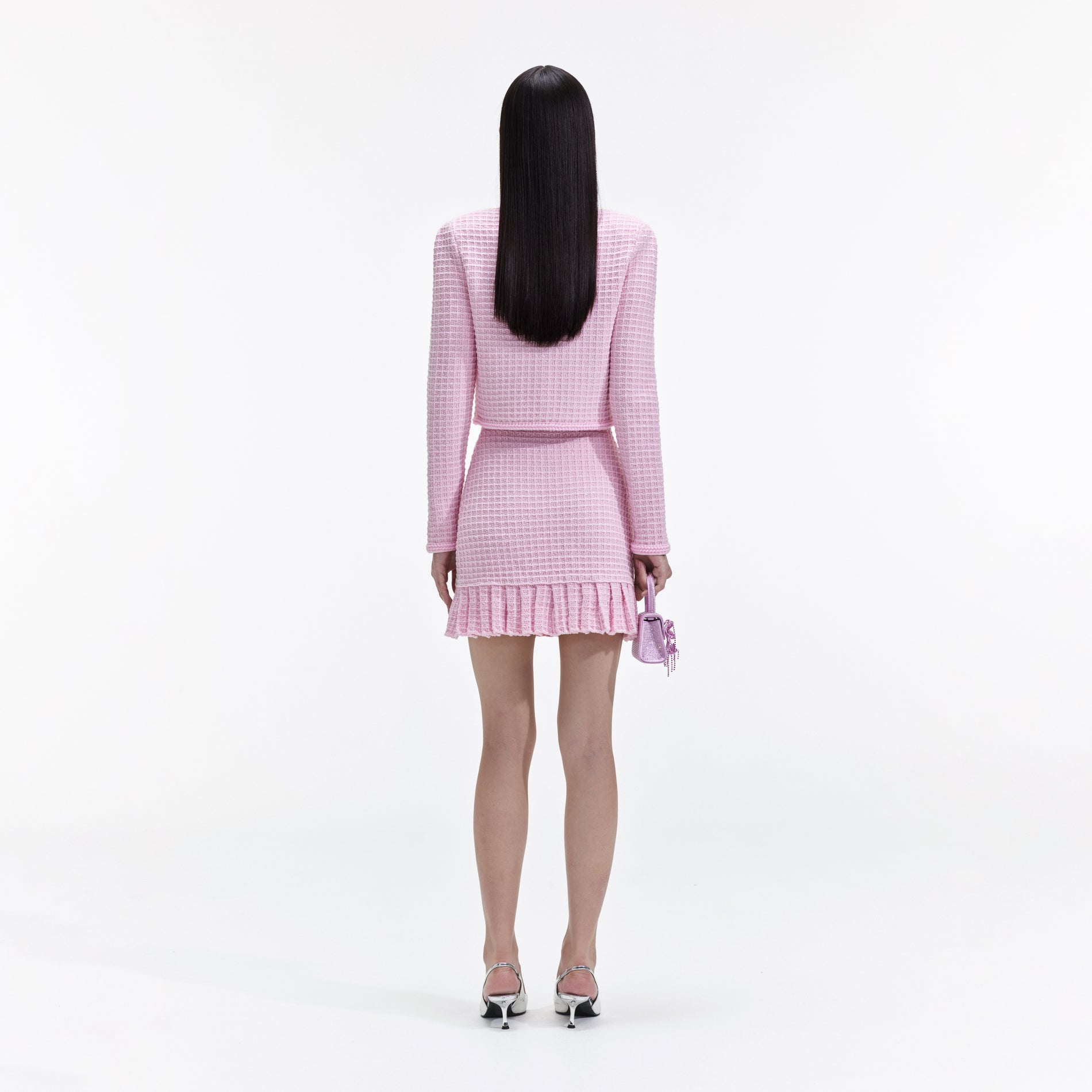 Back view of a woman wearing the Pink Sequin Textured Knit Jacket