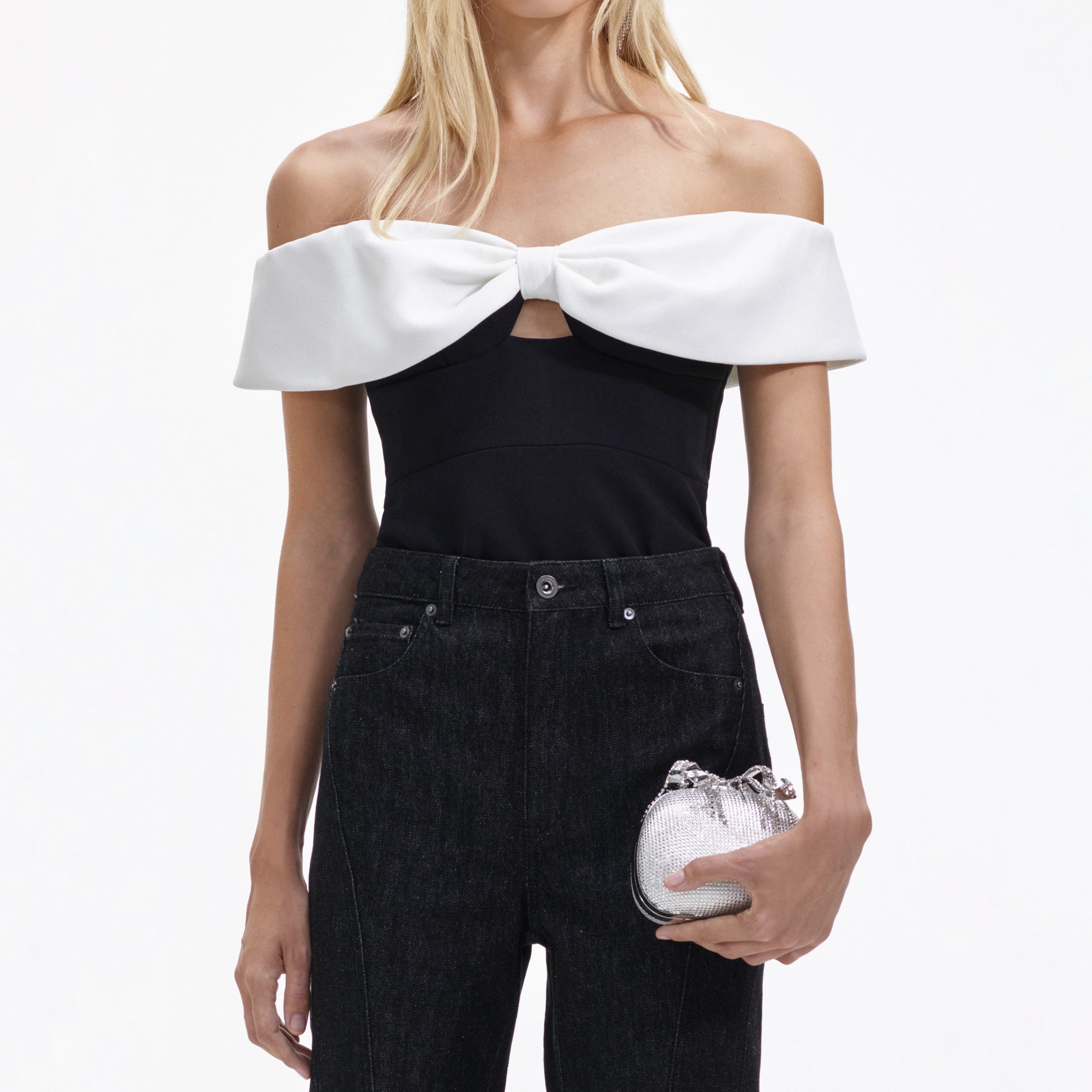 A close up of a woman wearing the Black Crepe Bow Top