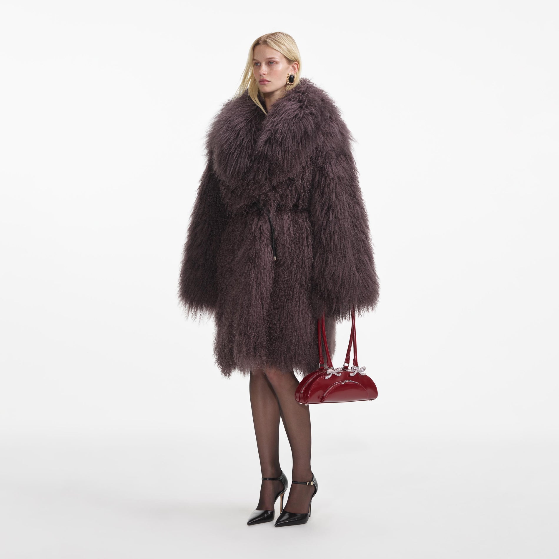 Side view of a woman wearing the Dark Brown Shearling Coat