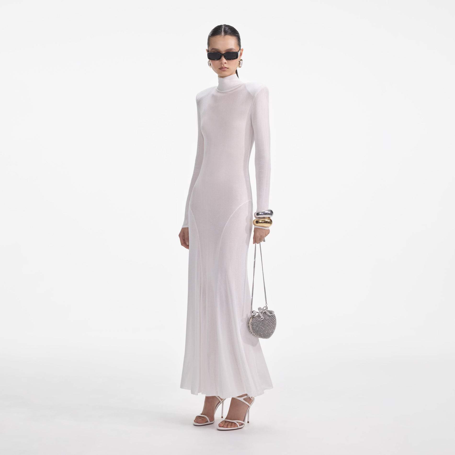 Side view of a woman wearing the White Viscose Knit Maxi Dress