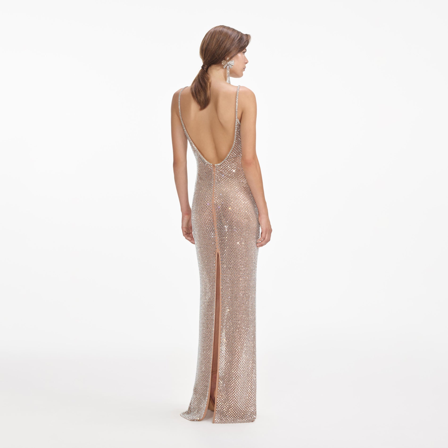 Back view of a woman wearing the Silver Rhinestone Fishnet Maxi Dress