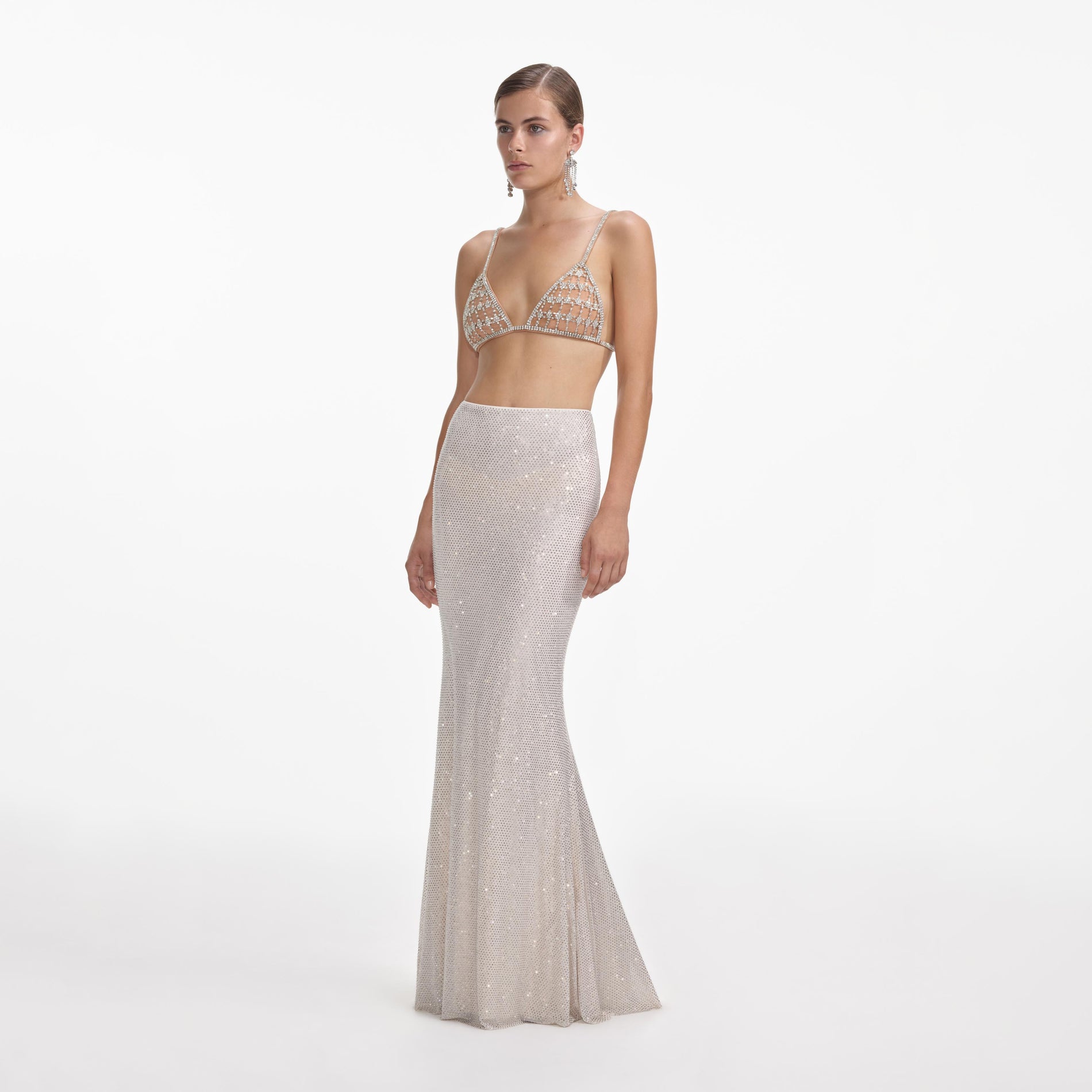 Side view of a woman wearing the Silver Rhinestone Mesh Maxi Skirt