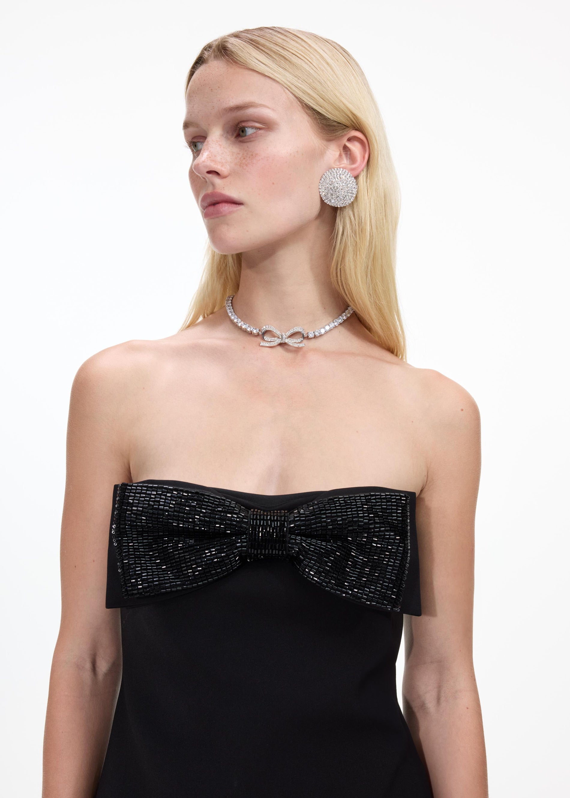 A close up of a woman wearing the Diamante Bow Tennis Choker