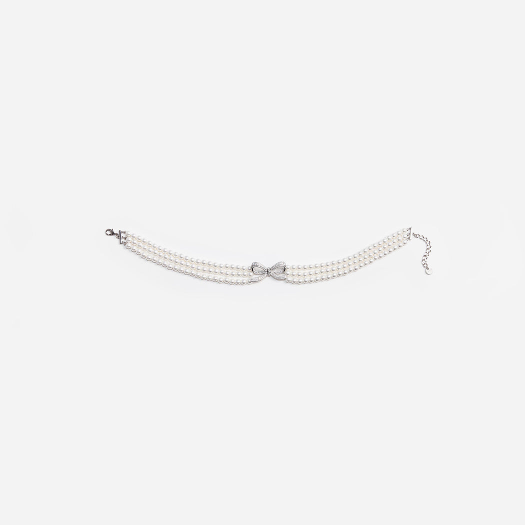 Side view of a woman wearing the Pearl Bow Choker