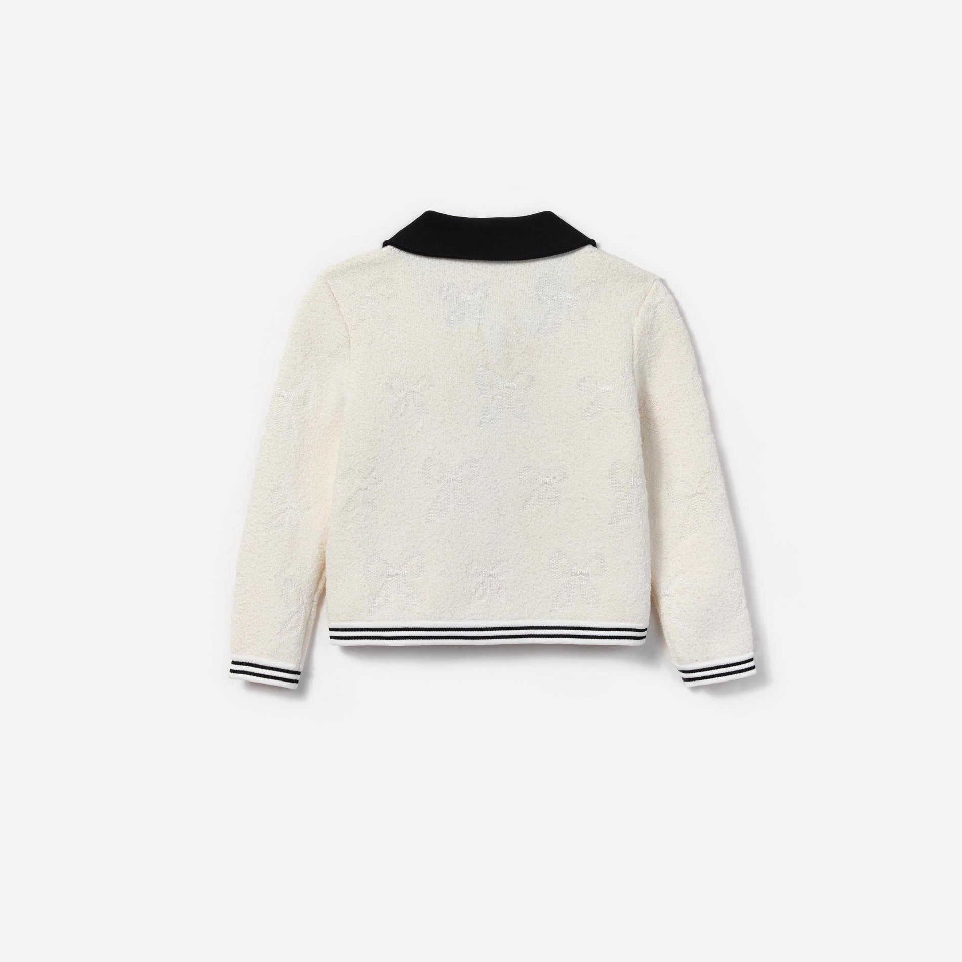 Side view of a woman wearing the White Jacquard Cardigan