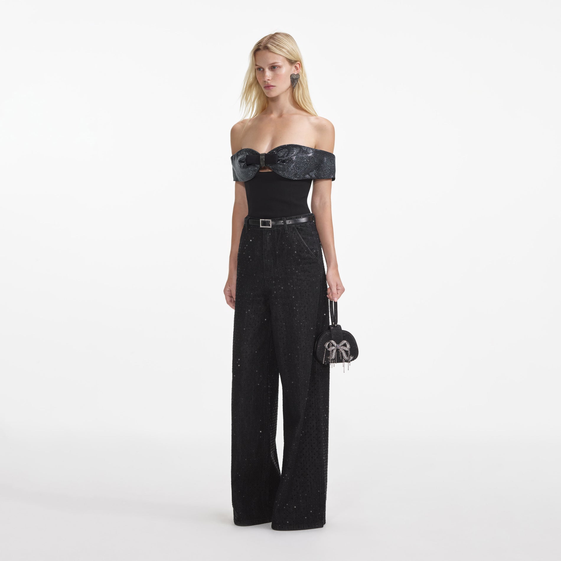 Side view of a woman wearing the Black Crepe Bow Top