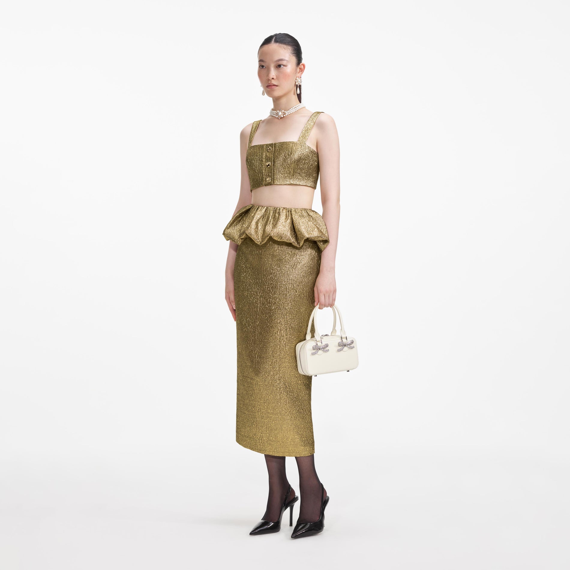 Side view of a woman wearing the Gold Metallic Jacquard Midi Skirt