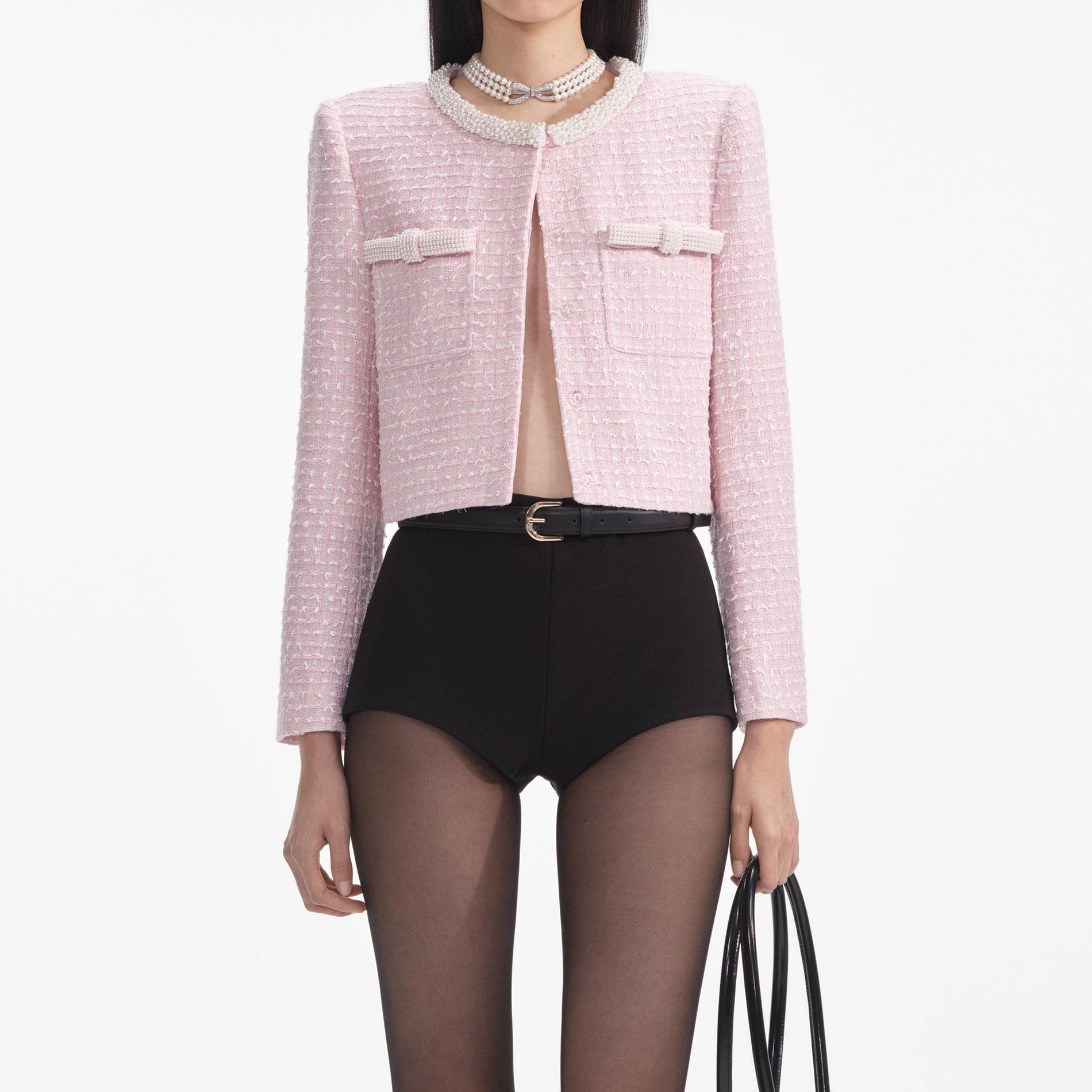 A close up of a woman wearing the Pink Boucle Pearl Trim Jacket