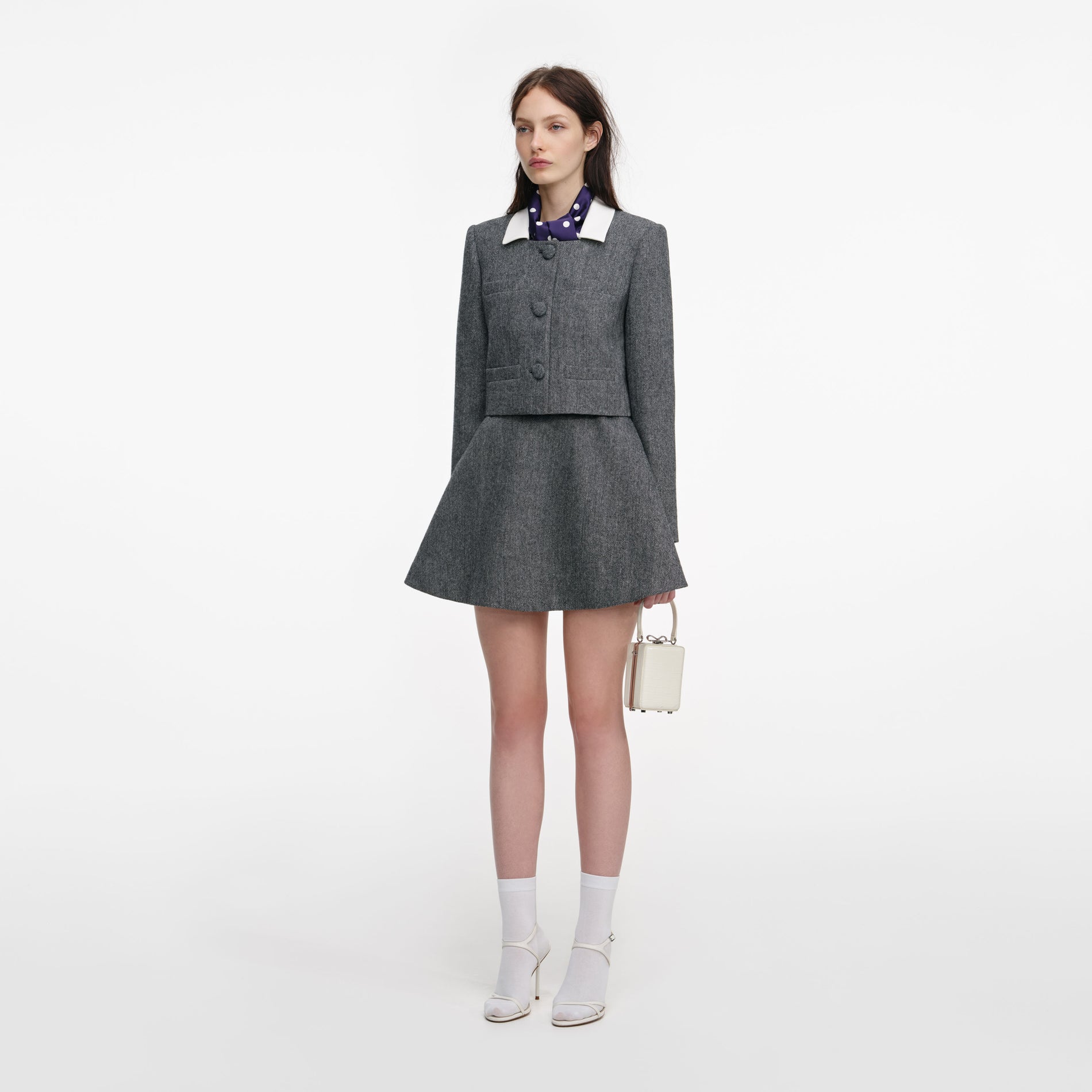 Side view of a woman wearing the Grey Herringbone Scarf Detail Jacket