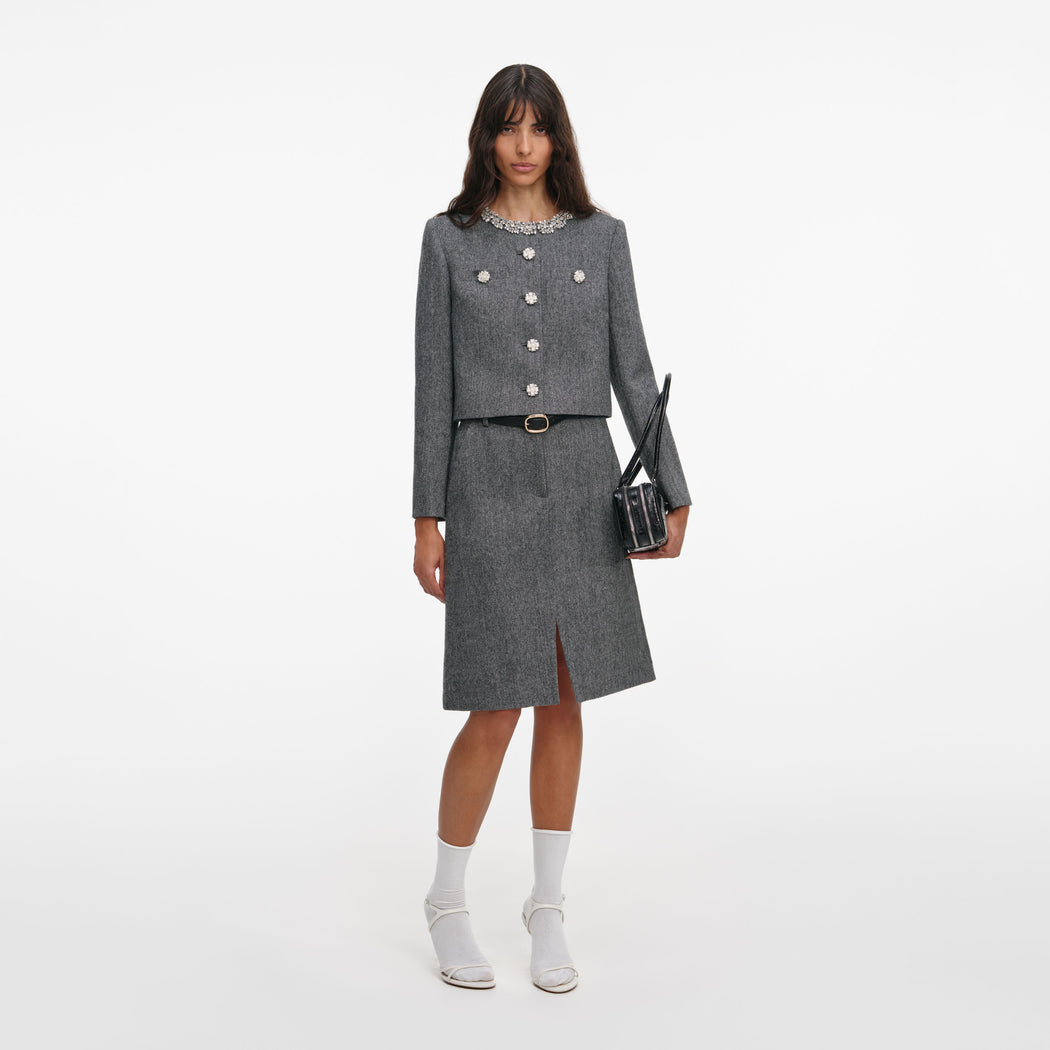 A close up of a woman wearing the Grey Herringbone Crystal Trim Jacket