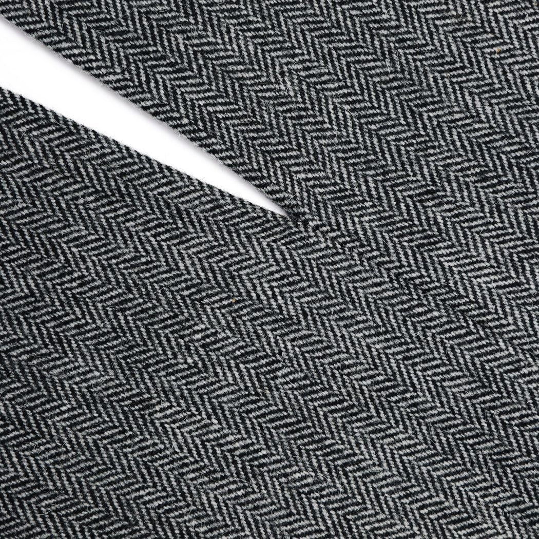 A close up of a woman wearing the Grey Herringbone Midi Skirt