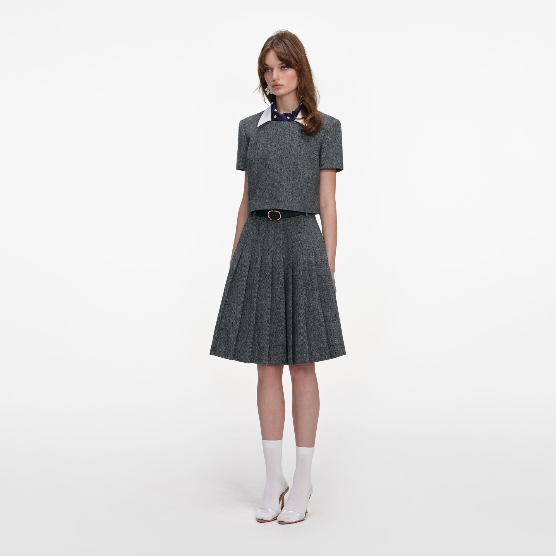 Side view of a woman wearing the Grey Herringbone Scarf Detail Top