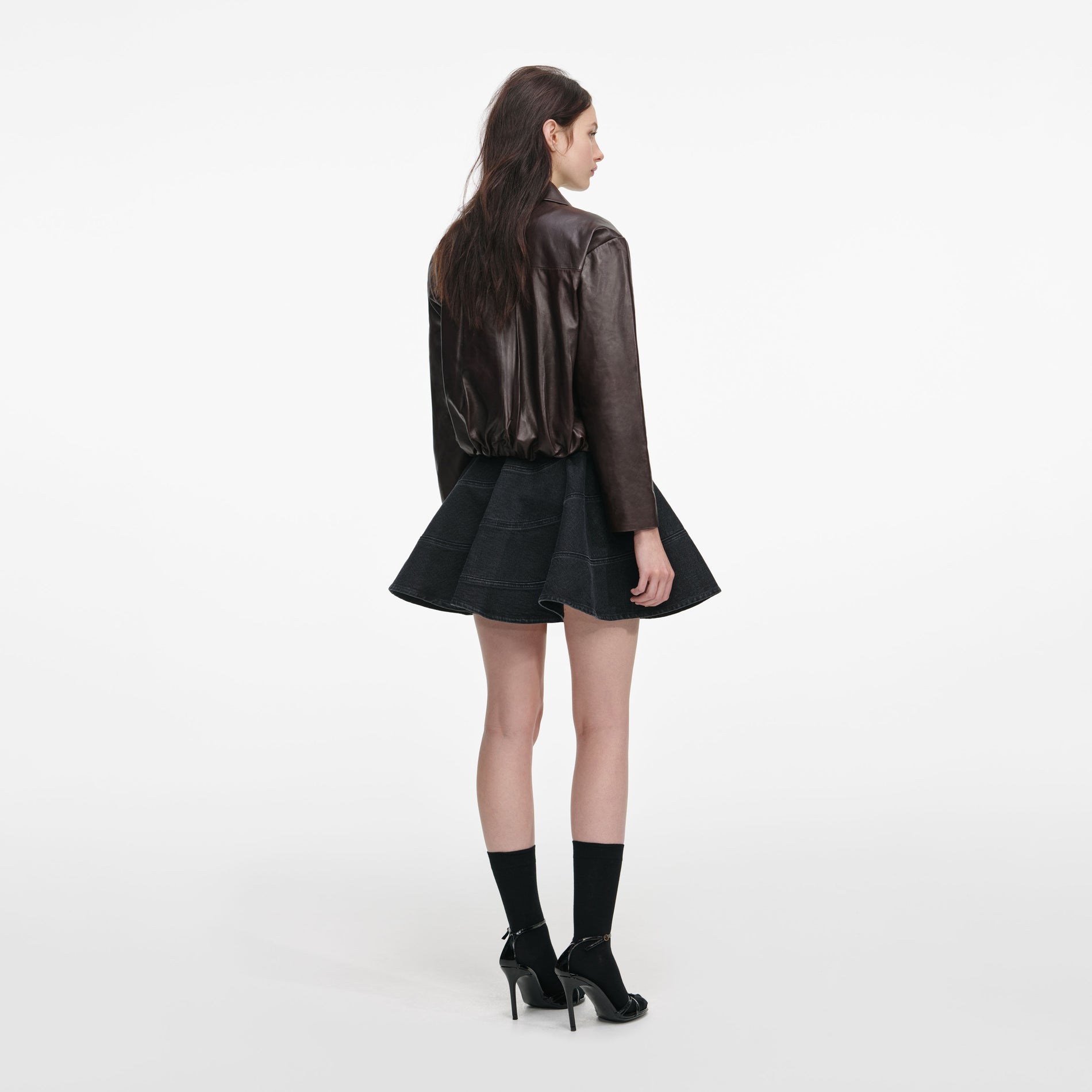 Back view of a woman wearing the Brown Cropped Leather Jacket