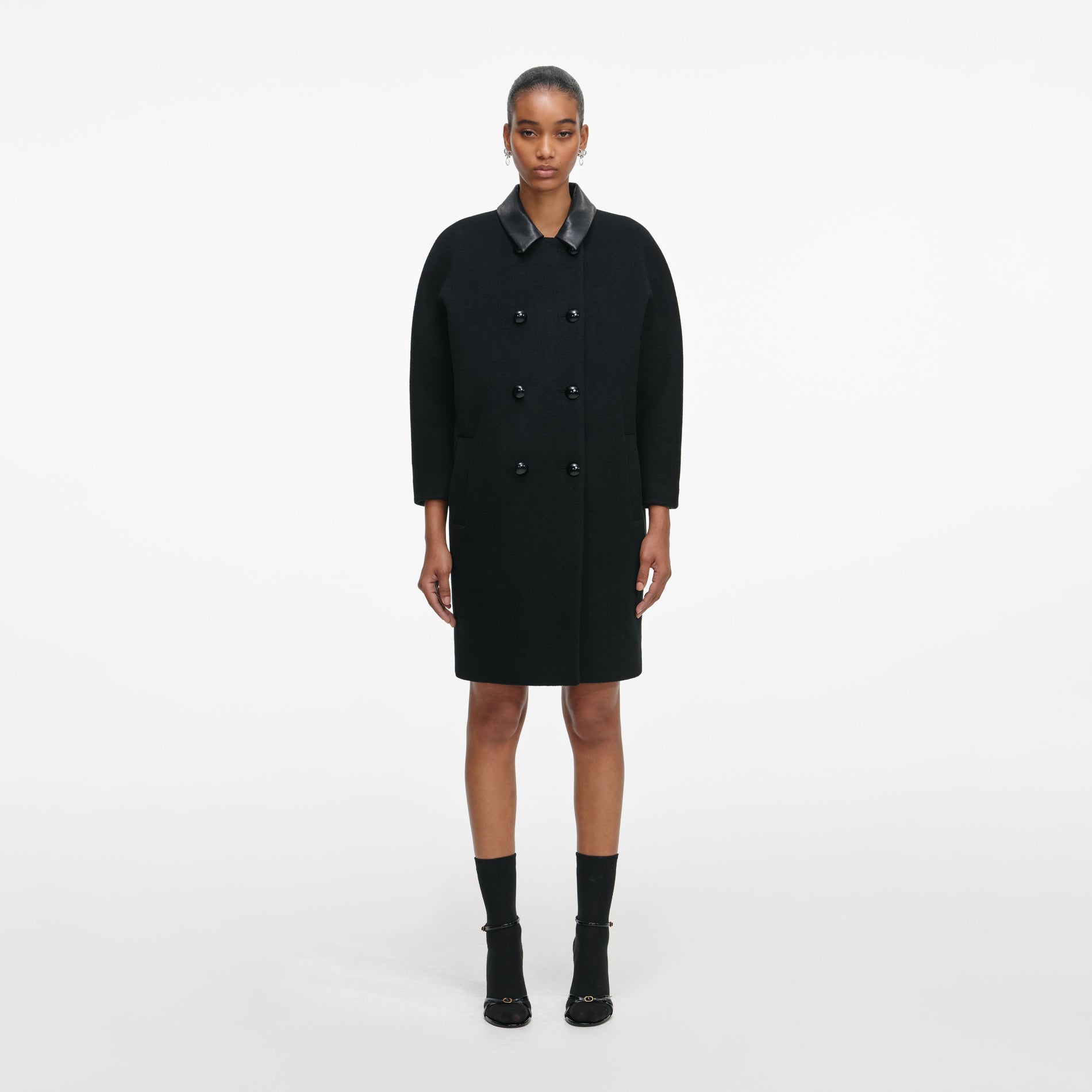 Front view of a woman wearing the Black Double Breasted Coat