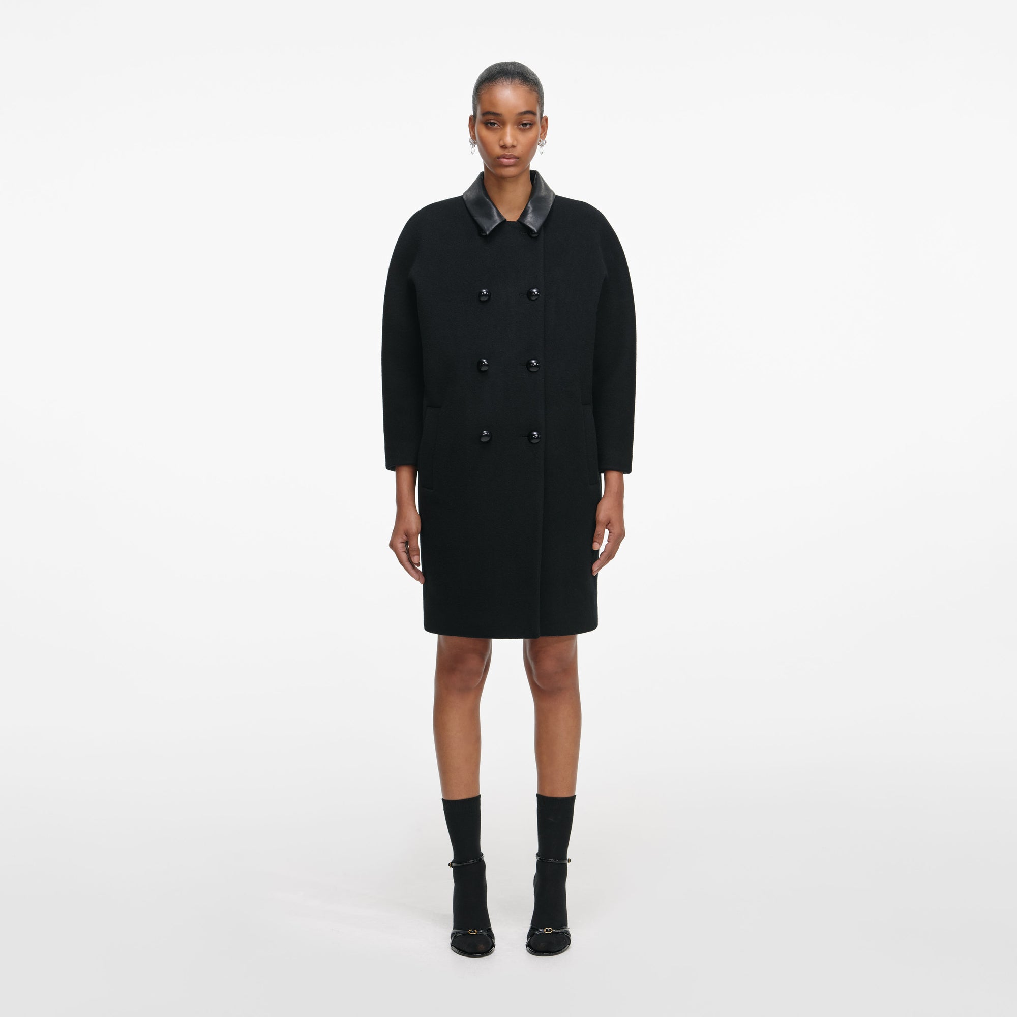 Front view of a woman wearing the Black Double Breasted Coat