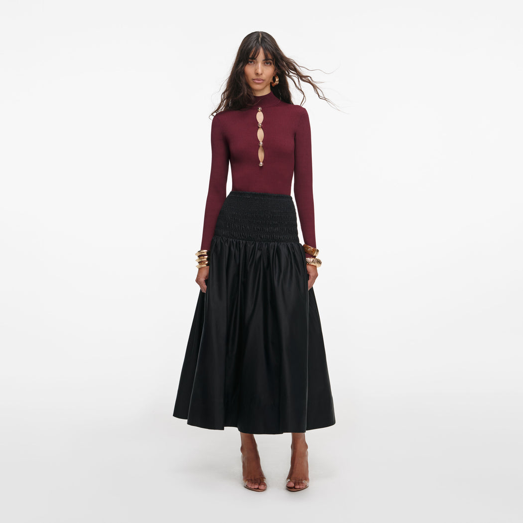 Front view of a woman wearing the Burgundy Keyhole Knit Top