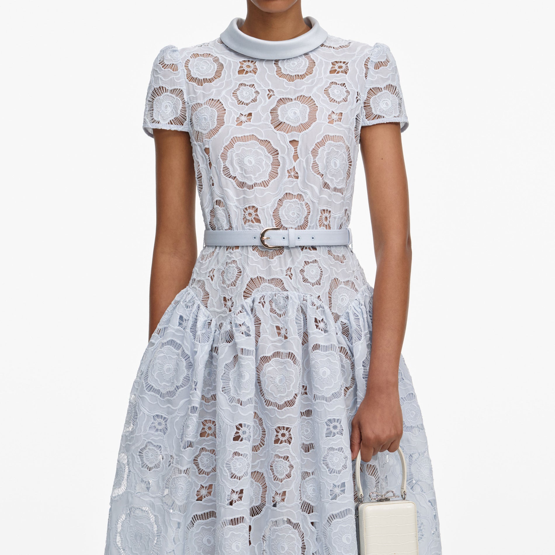 A close up of a woman wearing the Blue Floral Lace Midi Dress