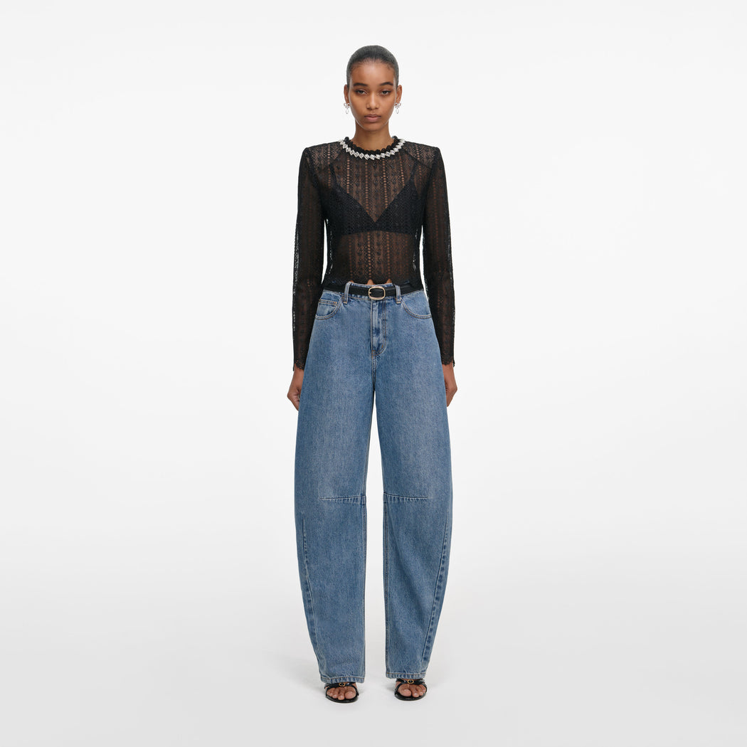 Front view of a woman wearing the Black Organza Lace Top