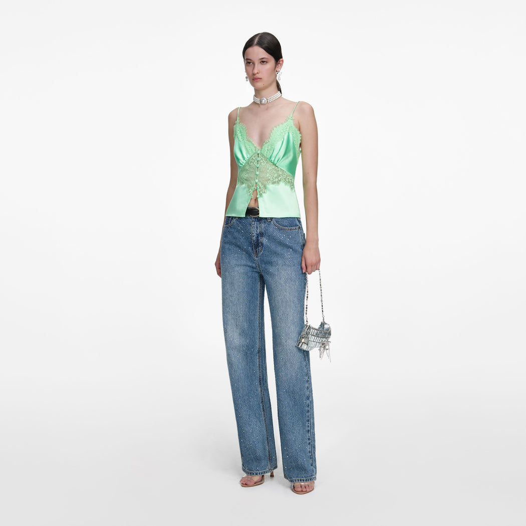 Side view of a woman wearing the Green Satin Lace Top