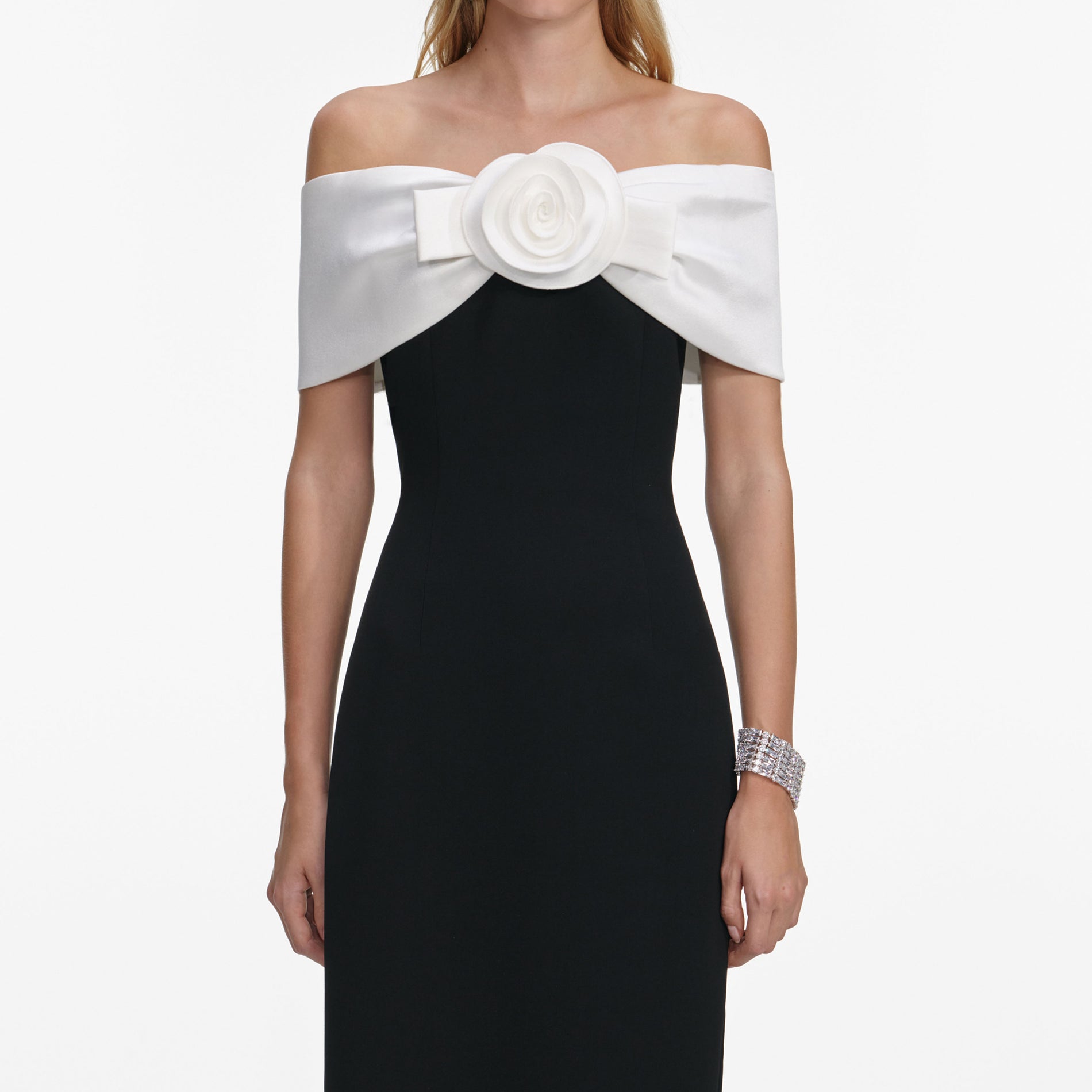 A close up of a woman wearing the Black Crepe Flower Maxi Dress