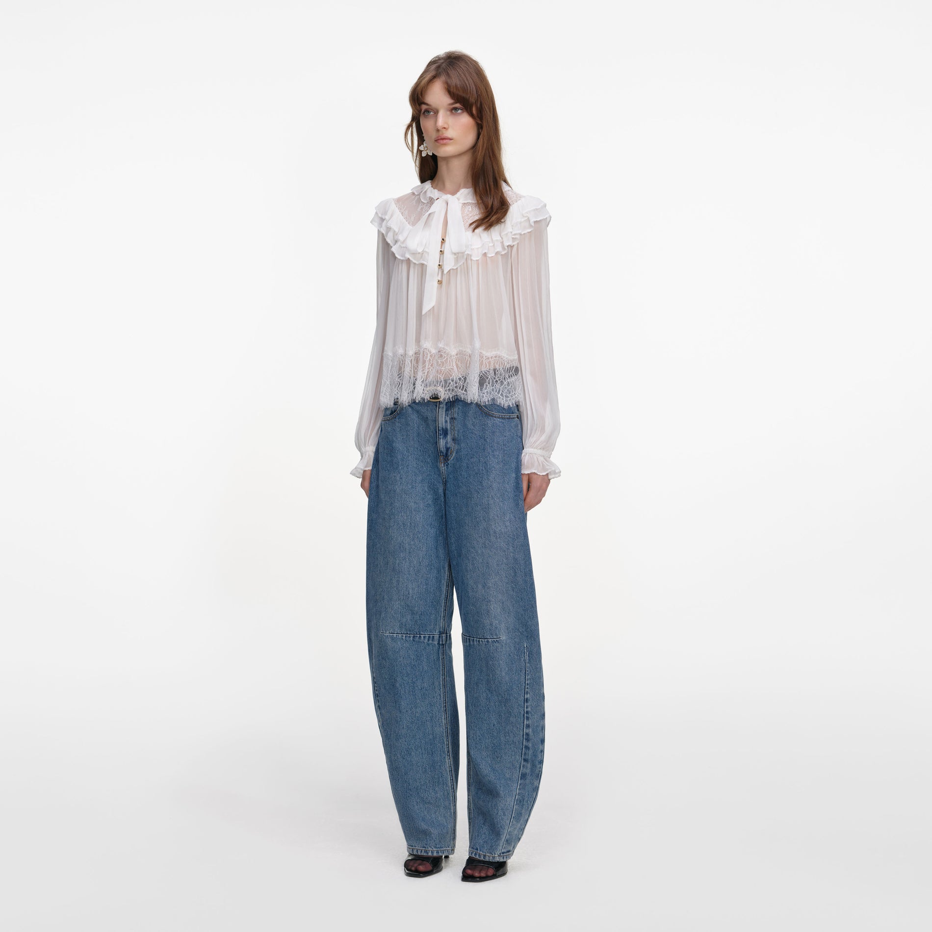 Side view of a woman wearing the White Georgette Lace Blouse