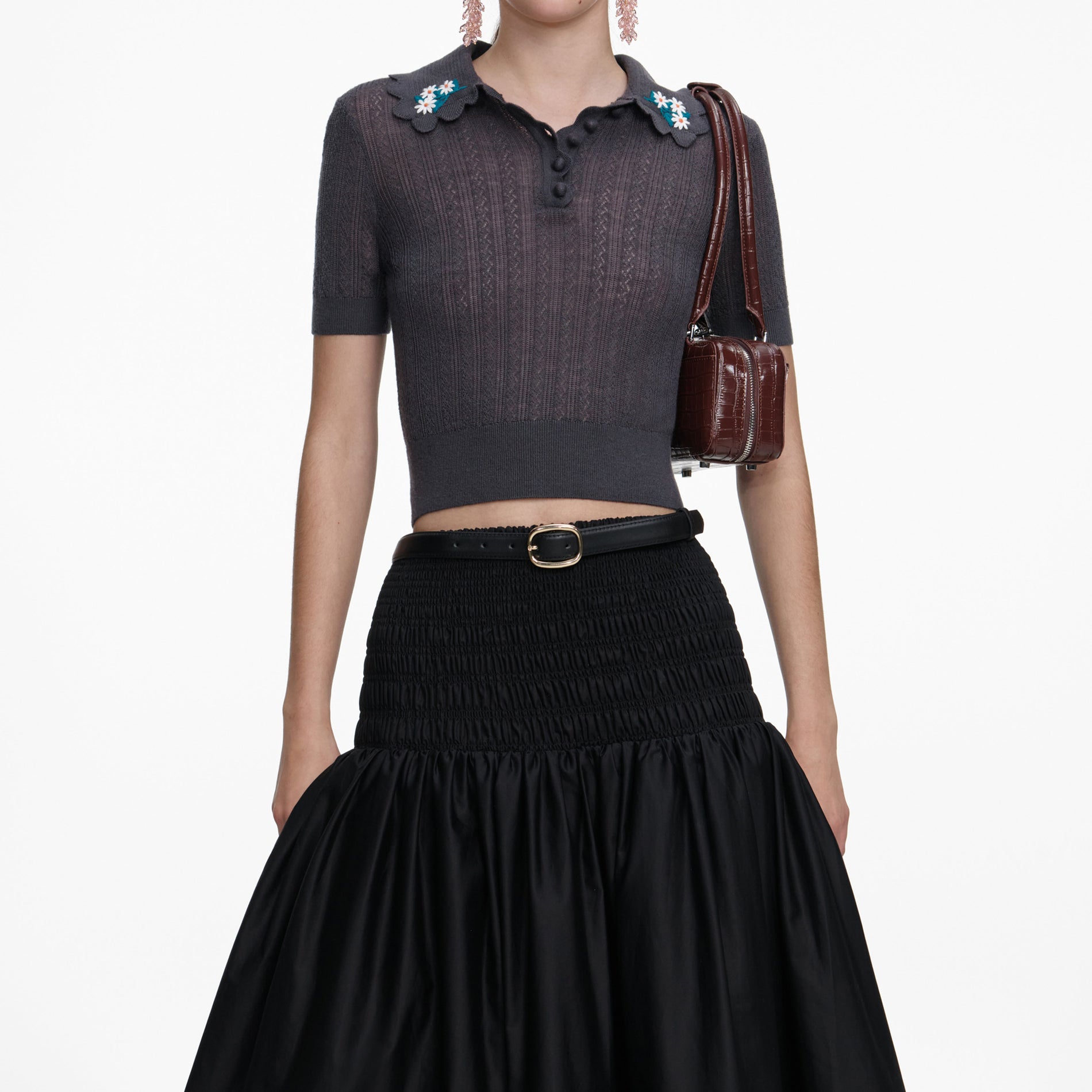 A close up of a woman wearing the Grey Embroidered Pointelle Knit Top