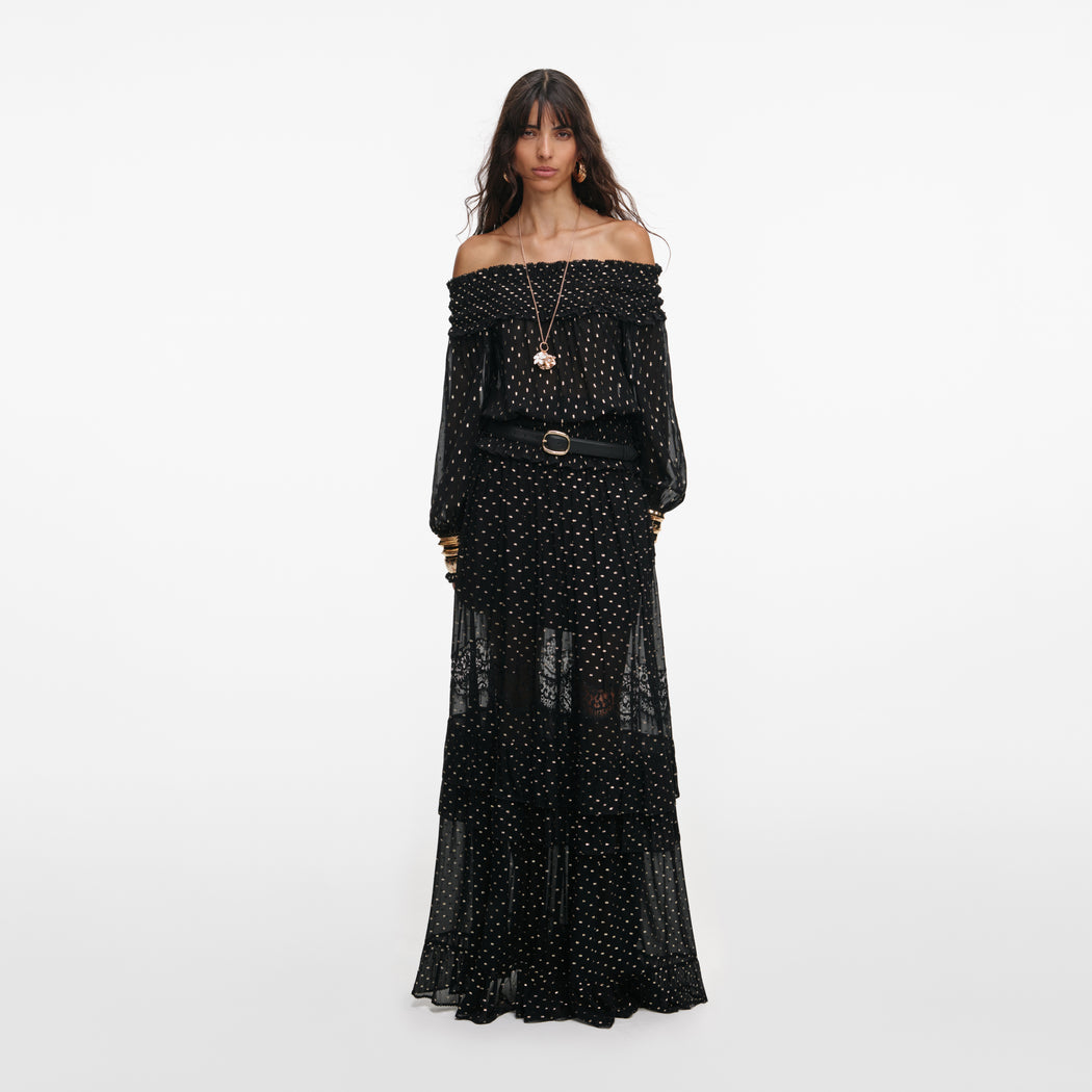 Front view of a woman wearing the Black And Gold Chiffon Lace Maxi Skirt