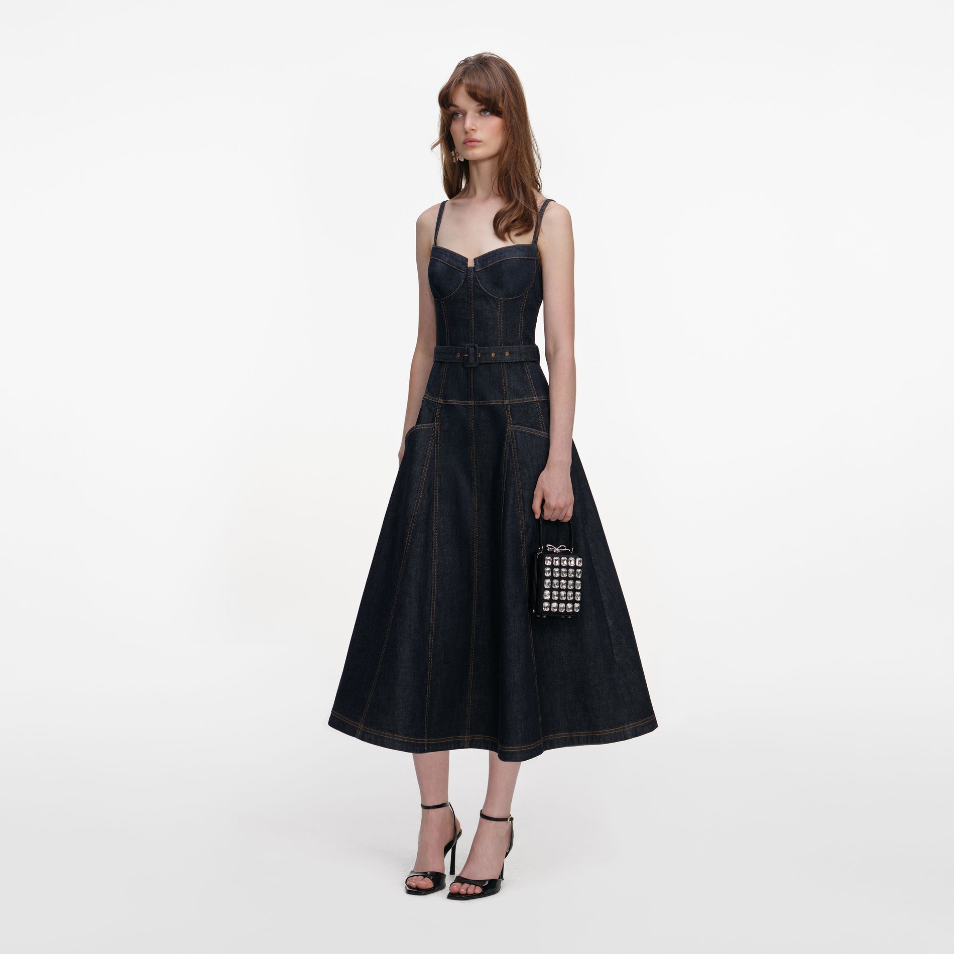 Side view of a woman wearing the Indigo Denim Flared Midi Dress