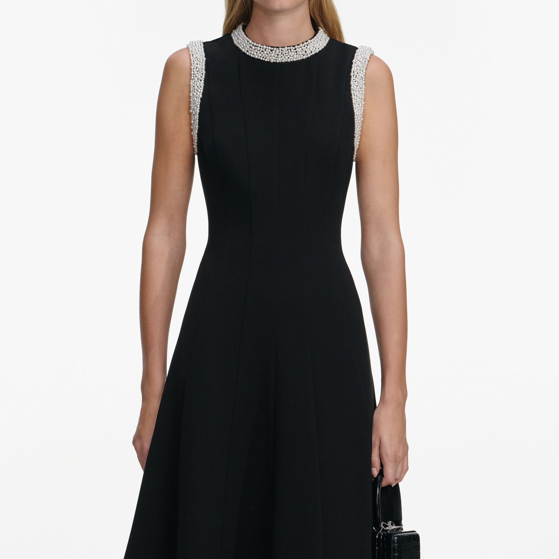 A close up of a woman wearing the Black Crepe Pearl Trim Midi Dress
