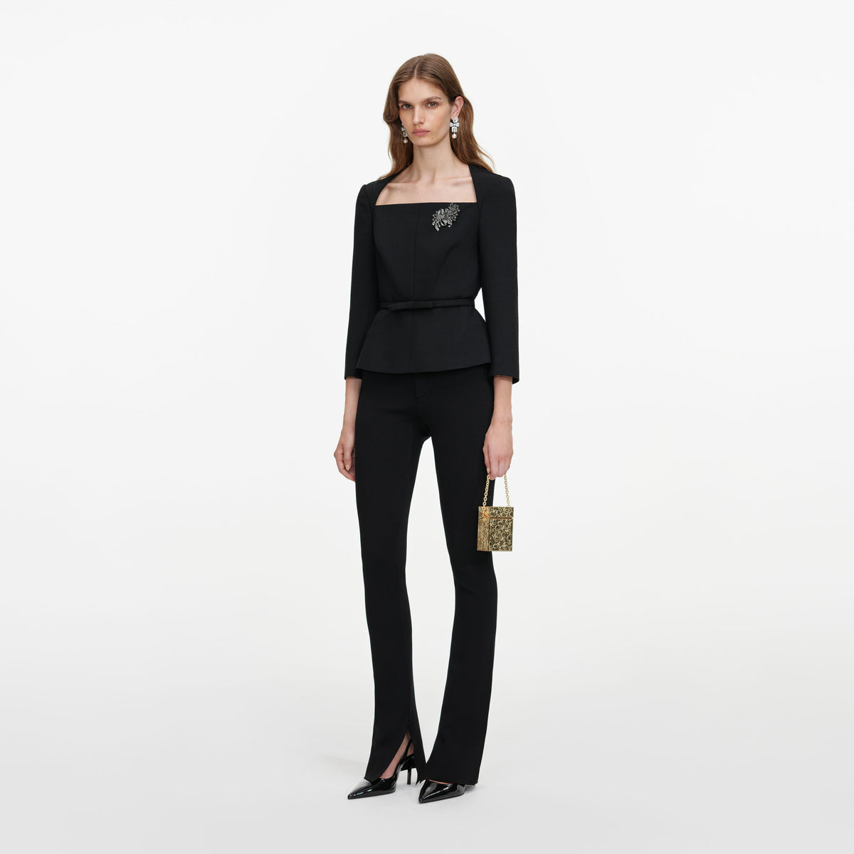 Side view of a woman wearing the Black Tailored Brooch Top