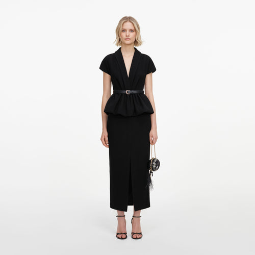 Front view of a woman wearing the Black Crepe Peplum Midi Dress